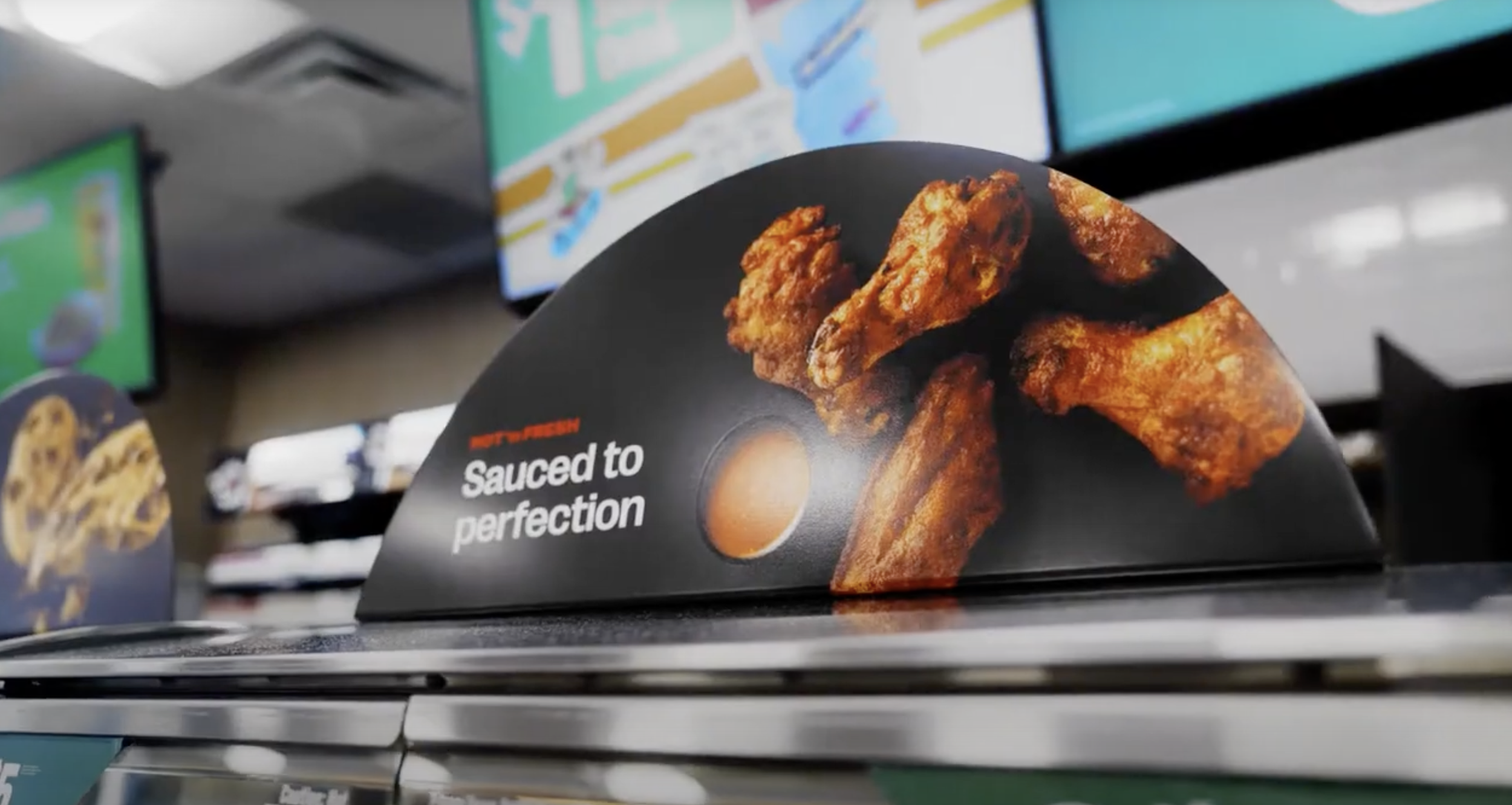 Fast food menu display advertising fried chicken with the caption 'Sauced to perfection'.