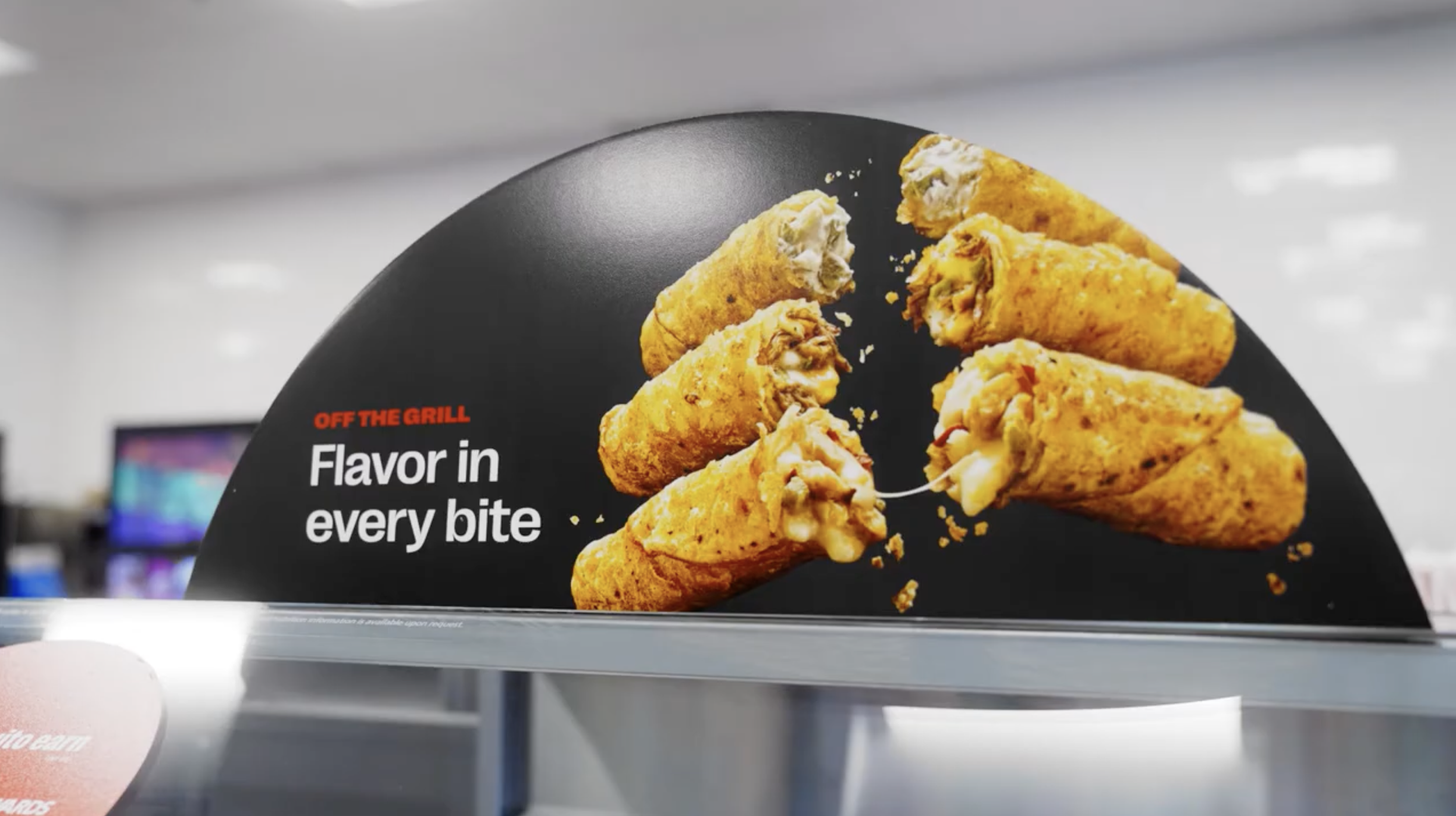 Advertisement for fried food items, displaying several golden-brown fried cones with creamy filling, alongside the text 'OFF THE GRILL Flavor in every bite' on a black background.