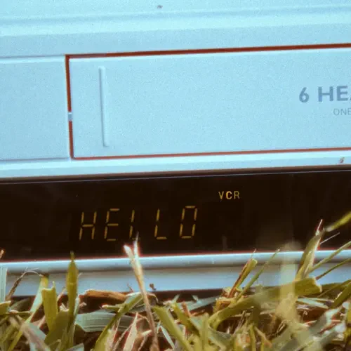 Close-up of a washing machine display showing the message 'HELLO' with laundry in the foreground.