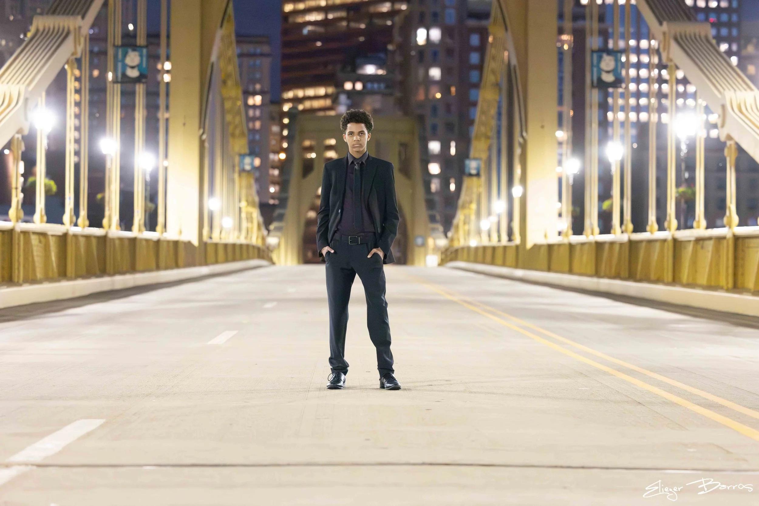 Senior pictures on Roberto Clemente Bridge in Pittsburgh with river and skyline views