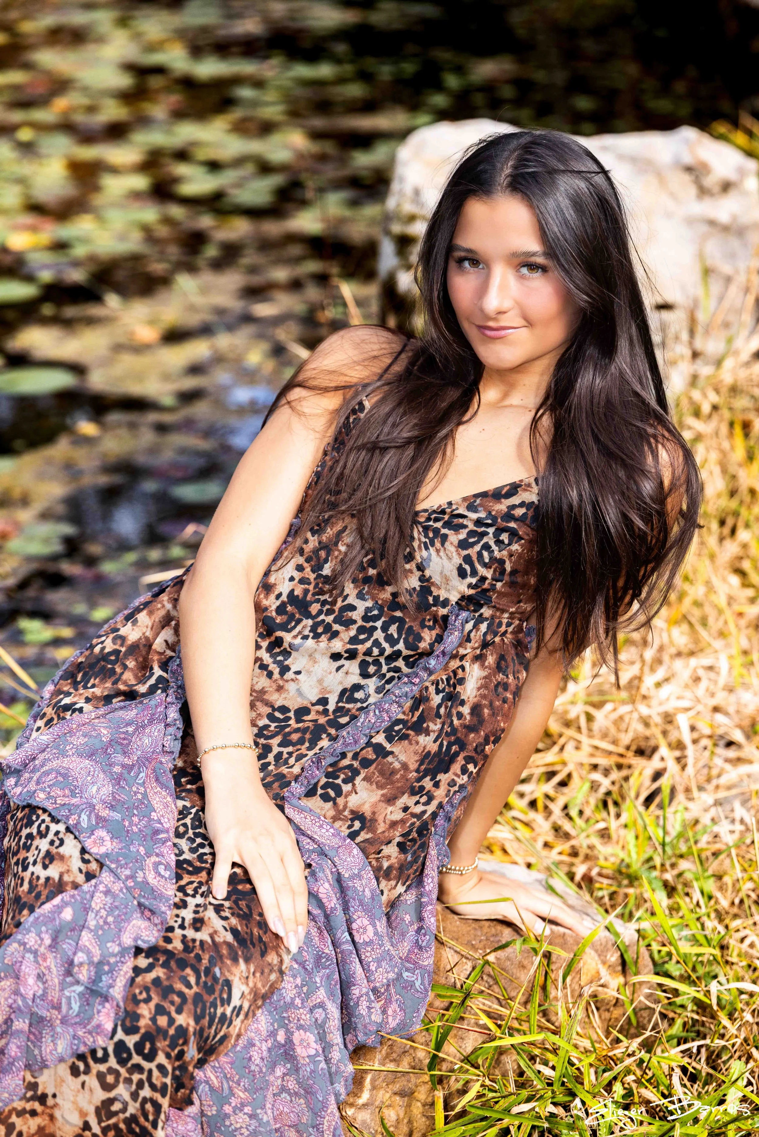 Class of 2026 senior Gianna posing by the water at Pittsburgh Botanic Garden during her fall senior session