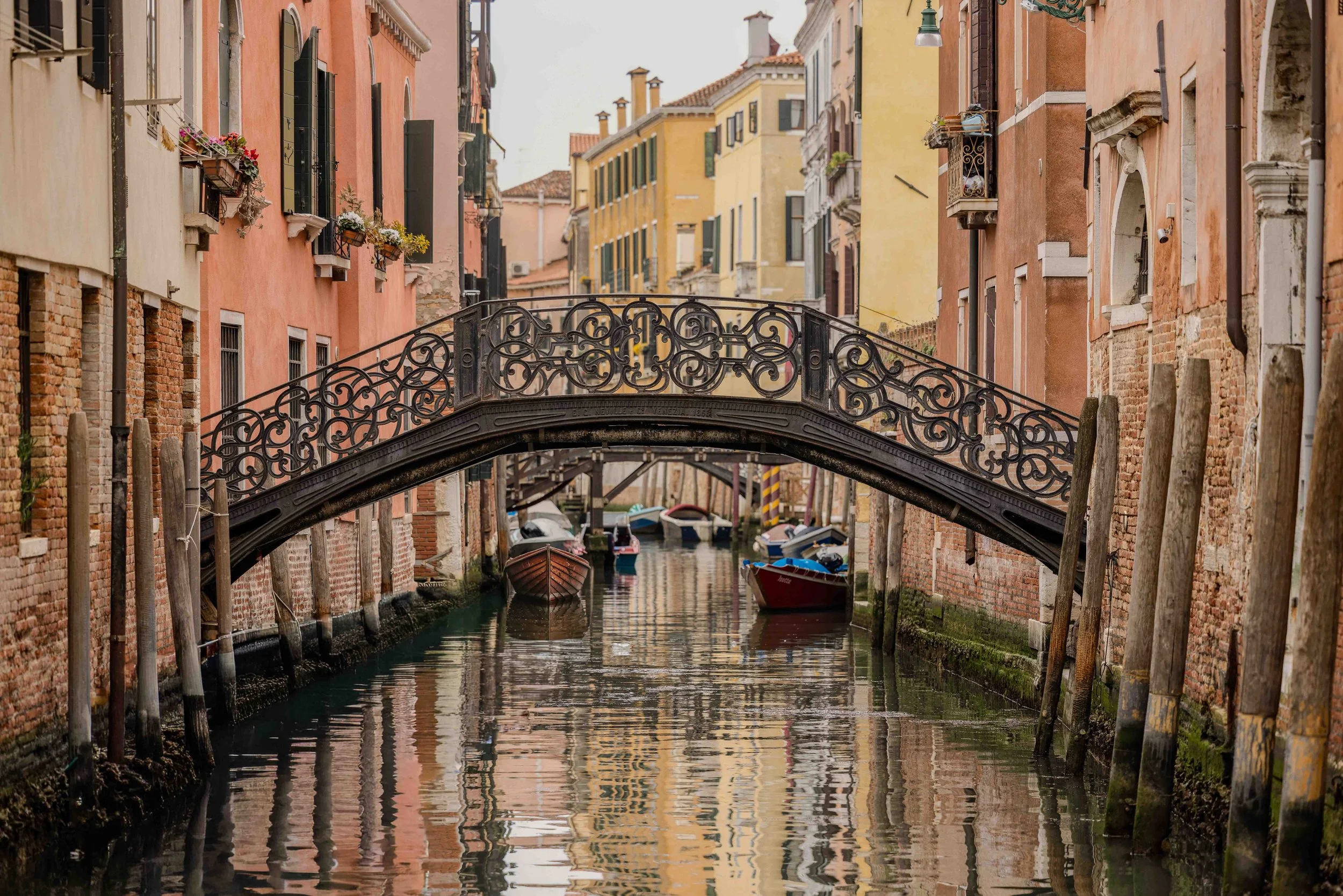 Venice canal fine art photography print featuring ornate bridge and colorful historic buildings reflected in calm water by Eliezer Barros