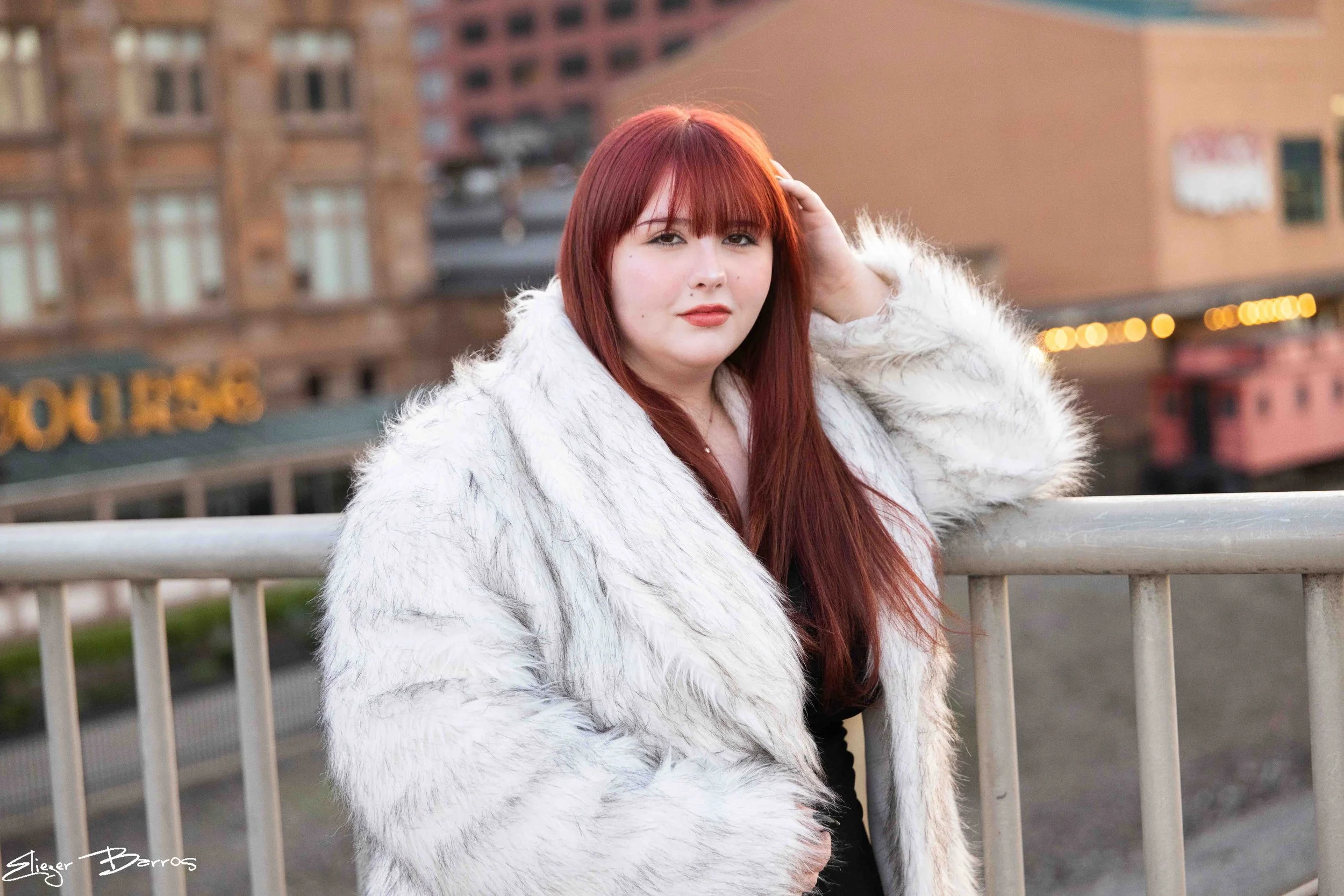 Sydney Class of 2027 senior pictures at Station Square Pittsburgh with red hair and white fur coat