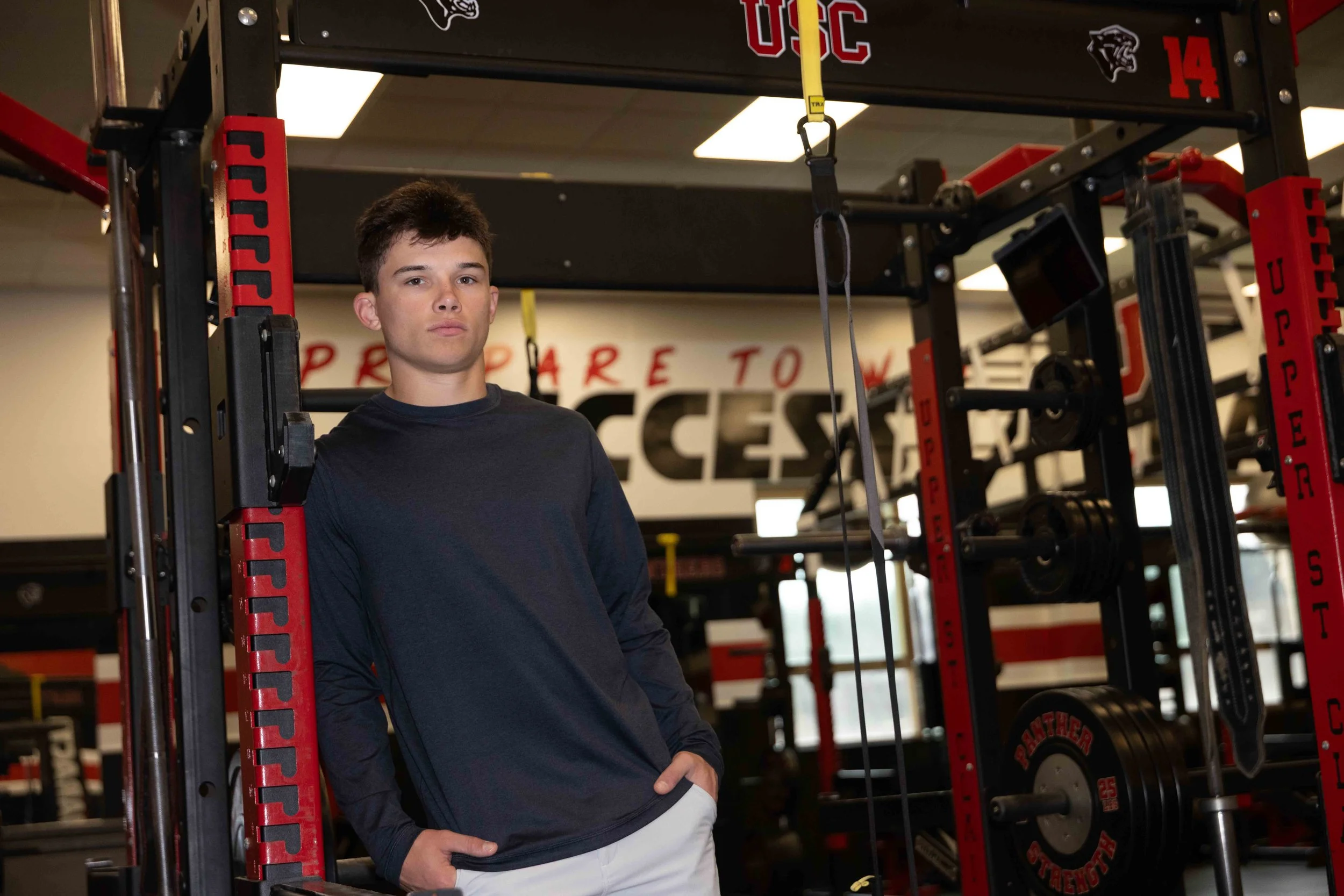 Class of 2026 Upper St. Clair senior Nico posing in the weight room at Upper St. Clair High School