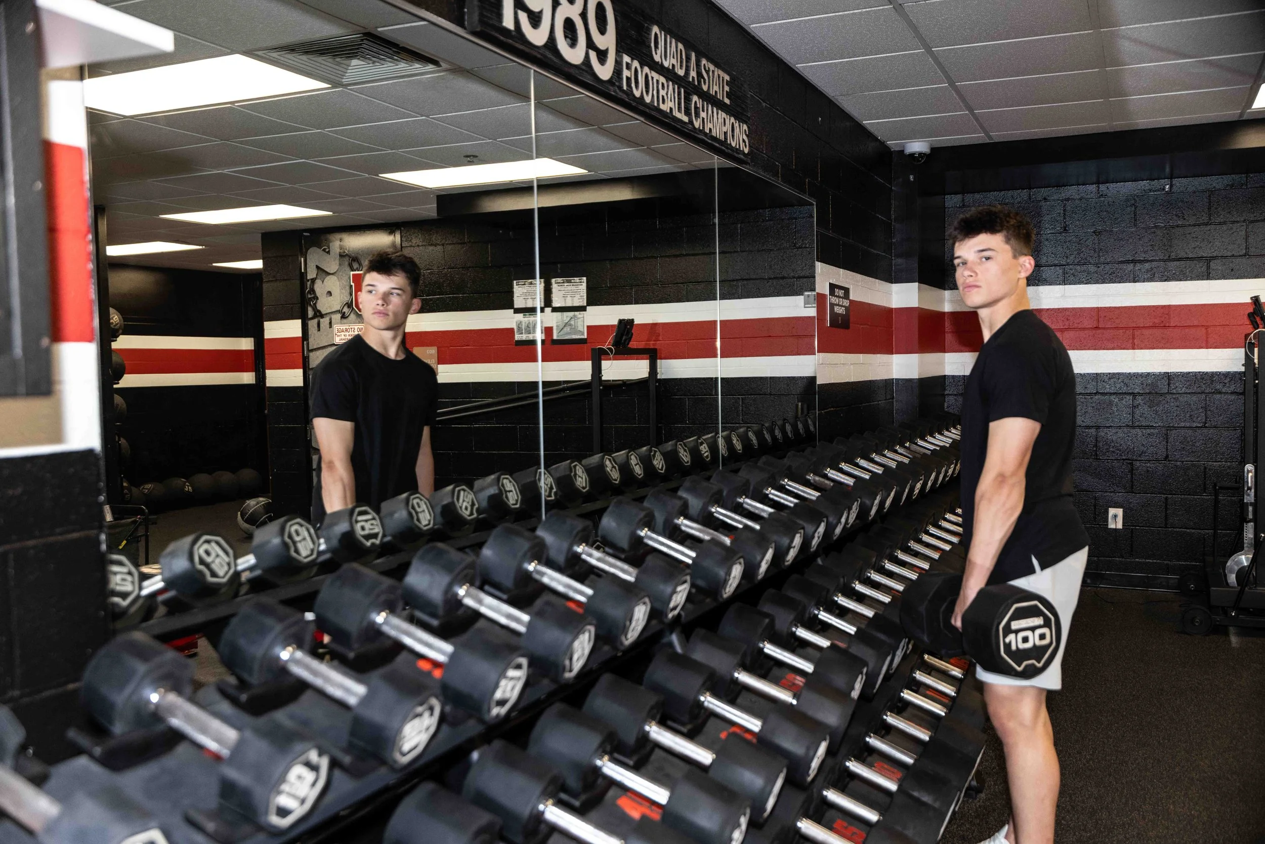 Class of 2026 Upper St. Clair senior Nico in the weight room hallway at Upper St. Clair High School