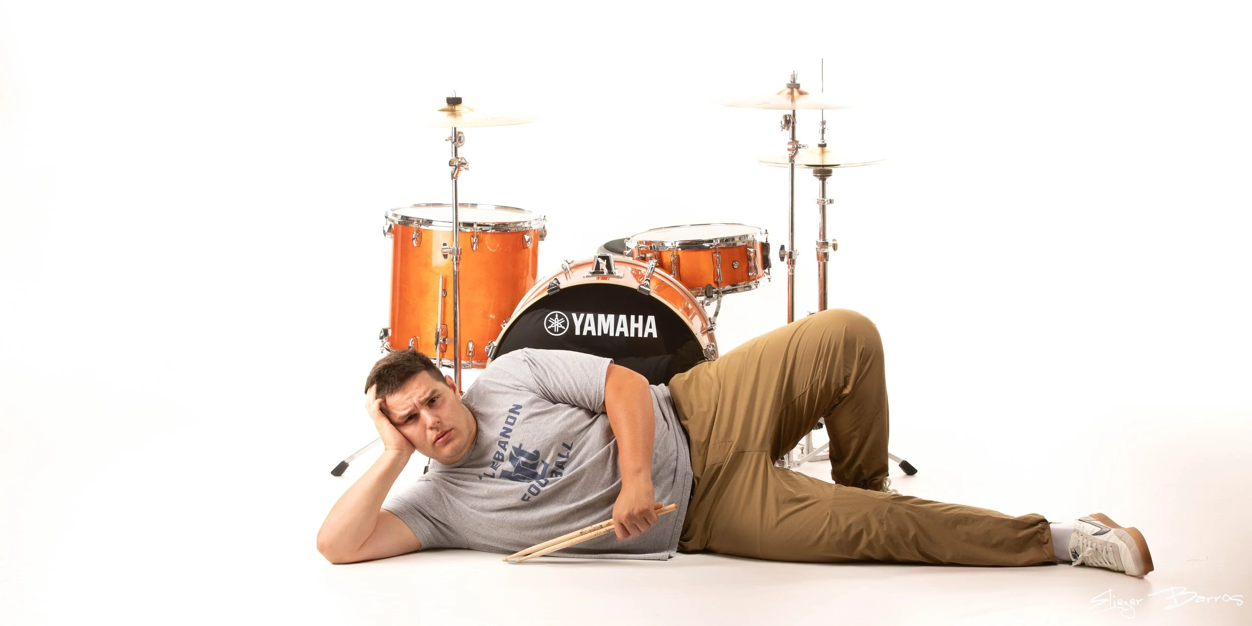 Creative senior pictures of a drummer with Yamaha drum kit in Pittsburgh studio