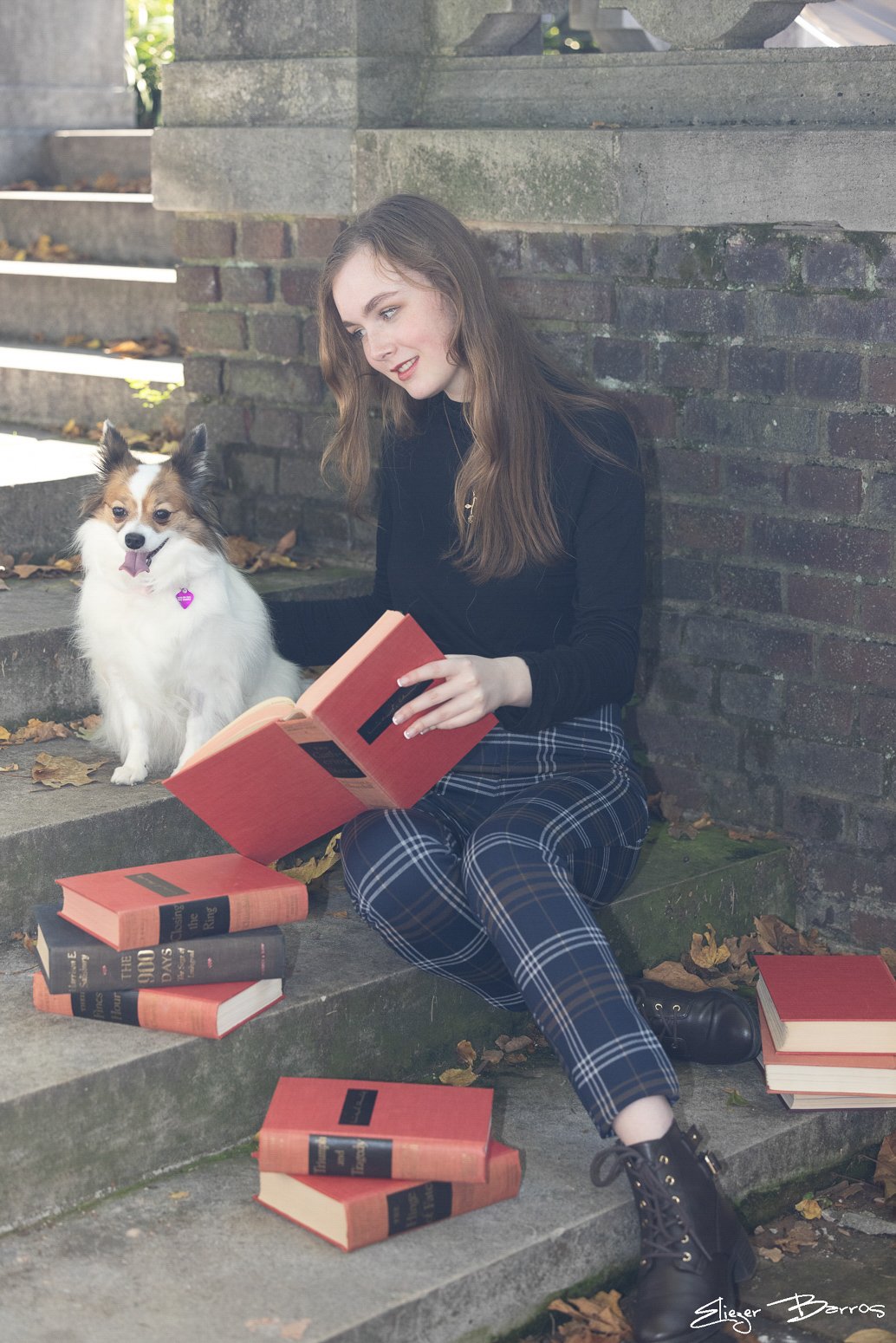 Senior Pictures Pittsburgh at Mellon Park. Young woman reading books on stone steps with her dog for a creative and artistic senior portrait session.