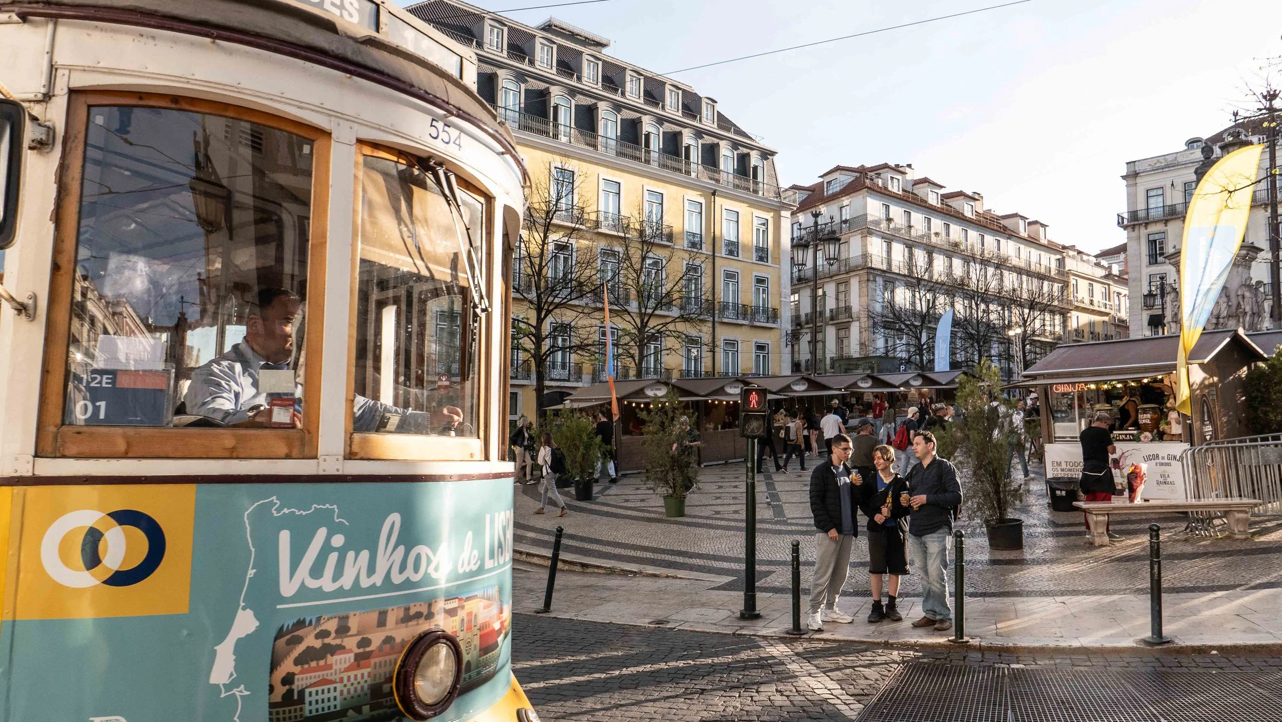Lisbon Portugal iconic yellow tram and bustling city square captured in vibrant travel photography by Eliezer and Esther Barros