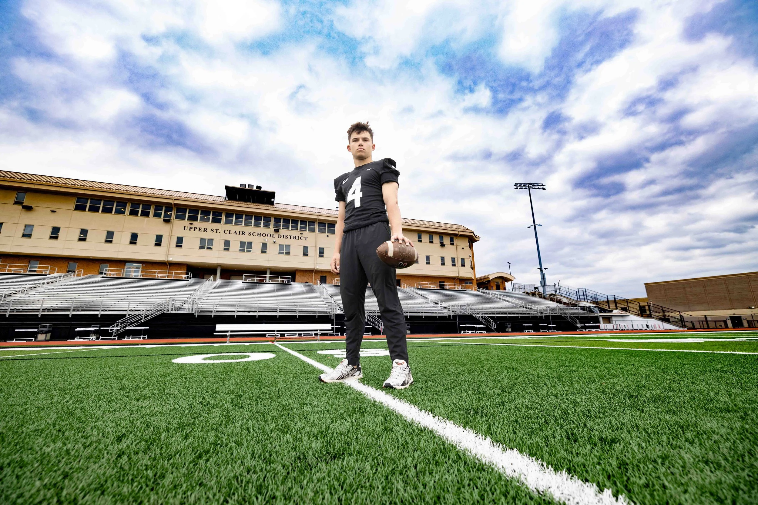 Class of 2026 Upper St. Clair senior Nico standing on the football field at Upper St. Clair High School during his senior pictures