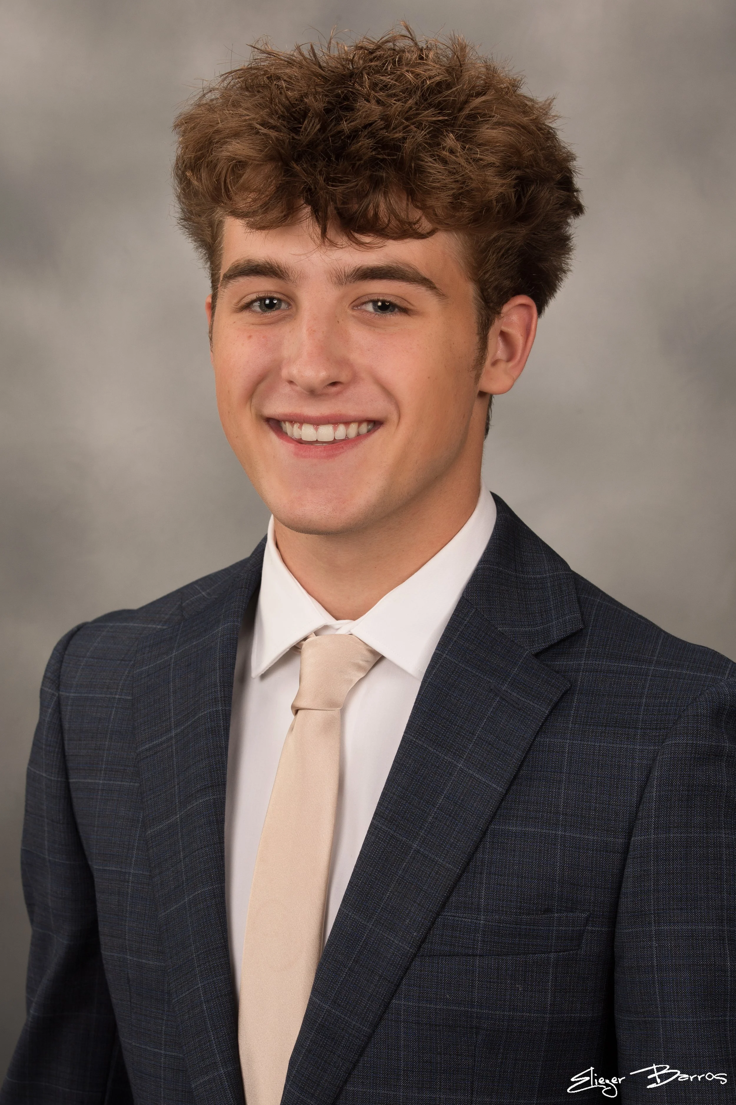 Studio senior yearbook pictures of a young man in suit from Mt. Lebanon