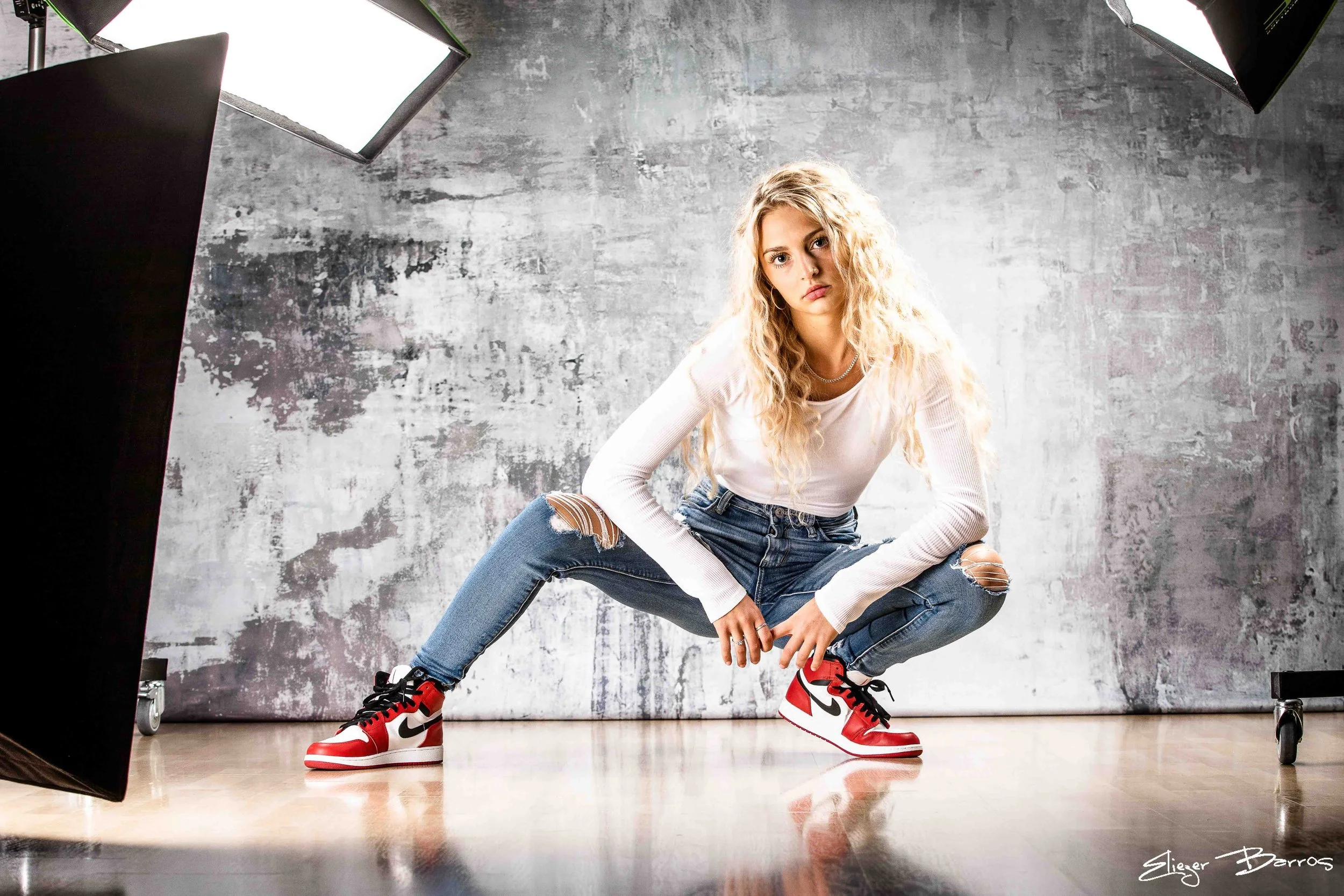 Pittsburgh senior pictures of a young woman with long blonde hair in studio session wearing red and white sneakers
