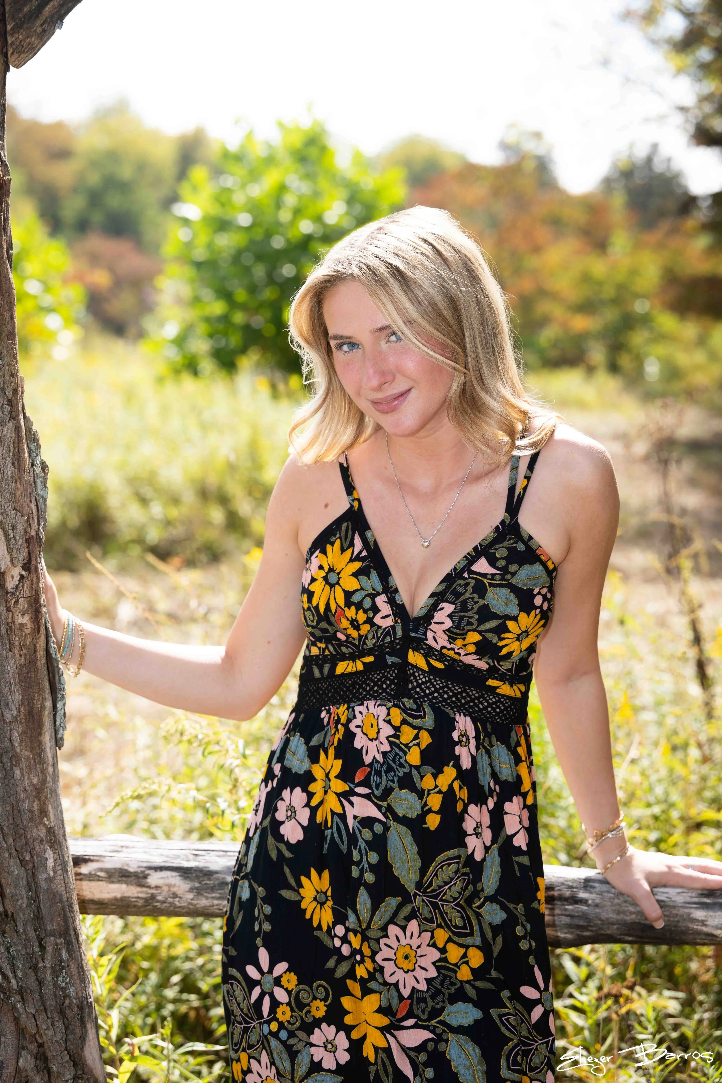 Class of 2026 Mt. Lebanon senior Kate in floral dress posing by a tree at Pittsburgh Botanic Garden