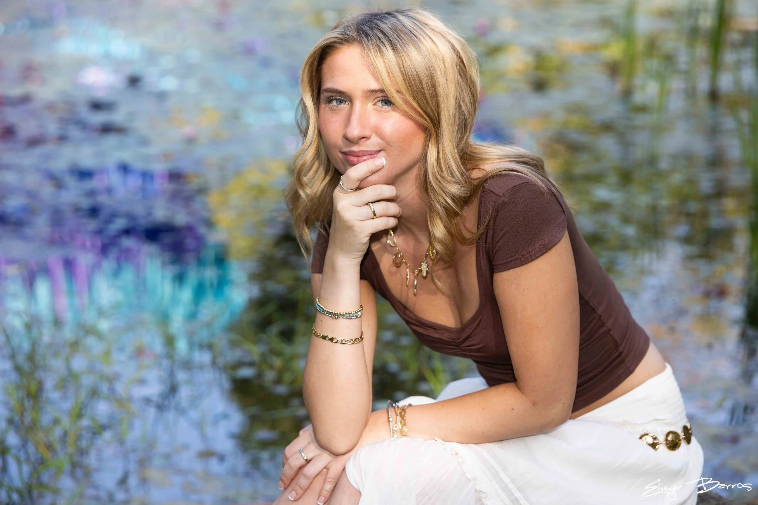Mt. Lebanon senior Kate posing thoughtfully by the water at Pittsburgh Botanic Garden