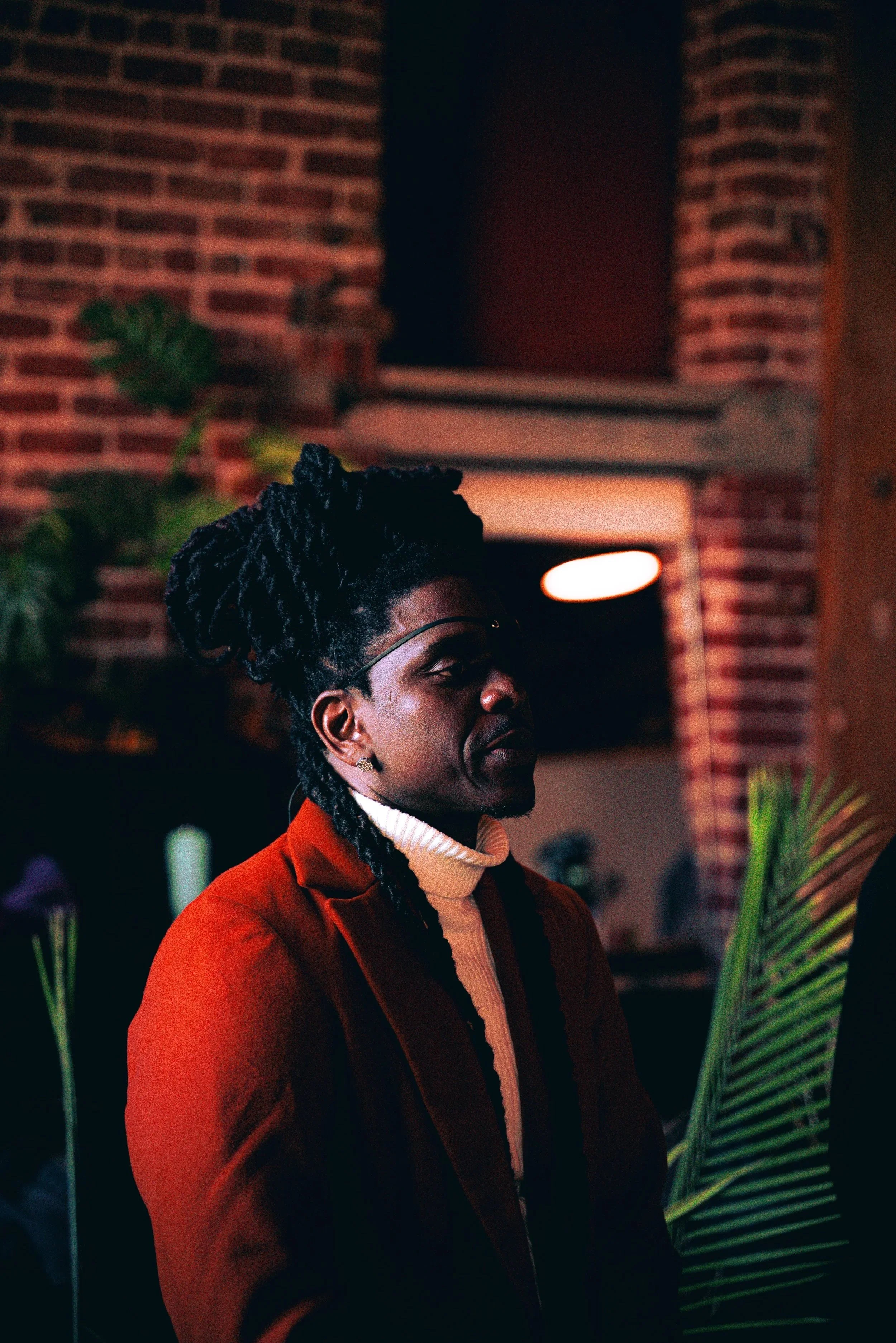 male model in orange looking off