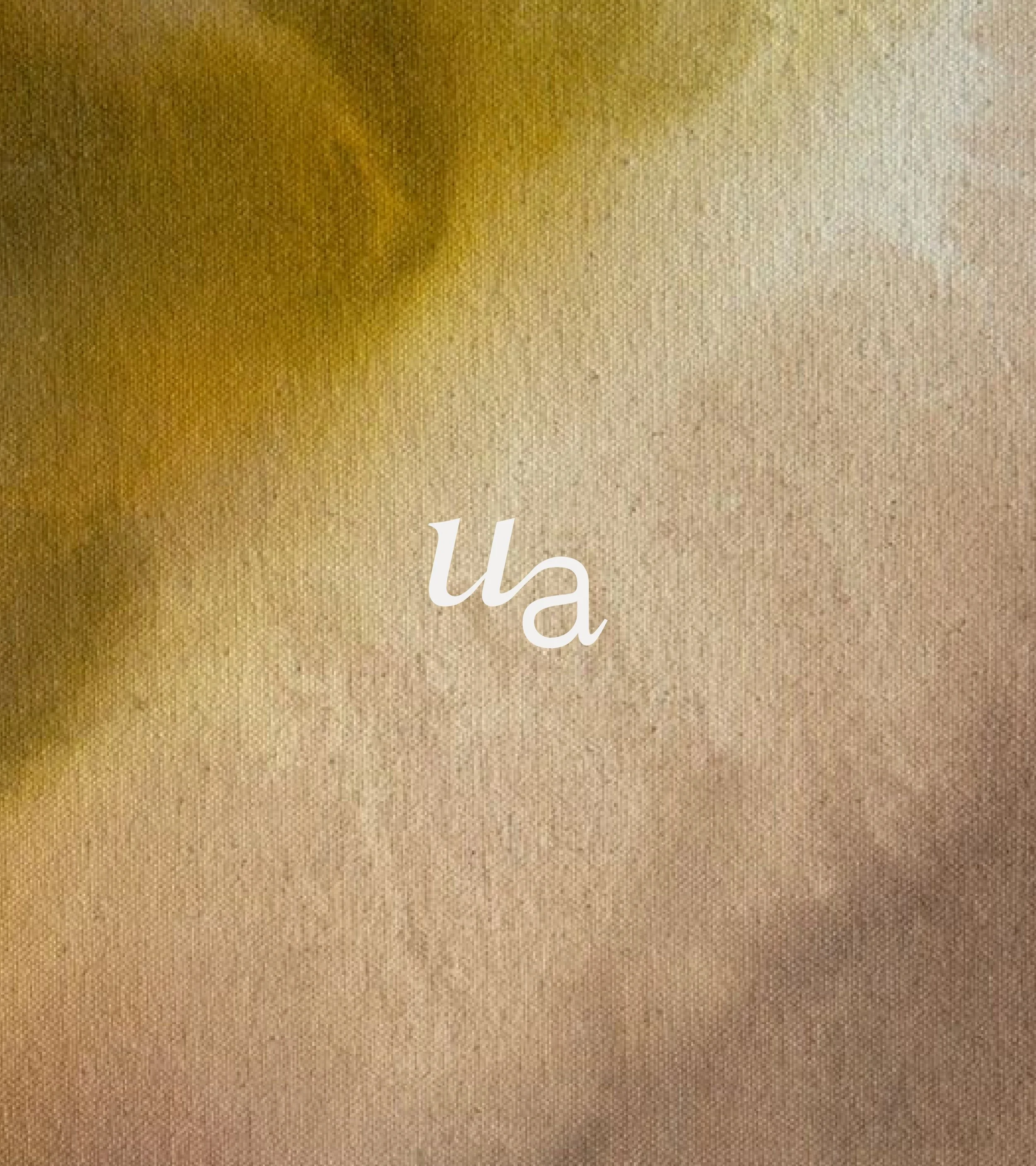 Close-up of a surface with gold and beige tones, featuring white text reading "U" and part of another letter on the lower section.