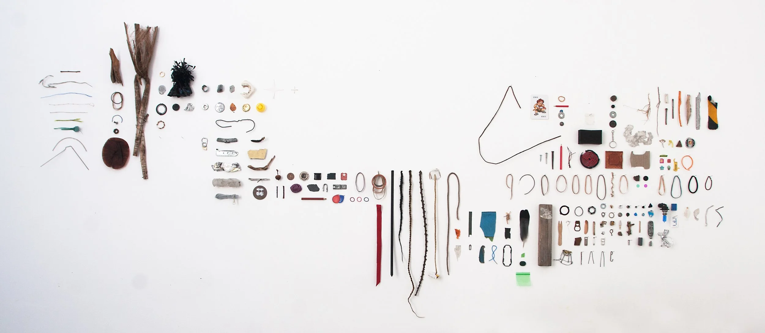 South End, 2014 | temporary installation, 245 cm x 115 cm, with found materials such as hair extensions, rubber bands, palm leave, muffin wrapper, wire, metal pins, nails, light bulb, tape, card board, sponge, play card, wood, etc.