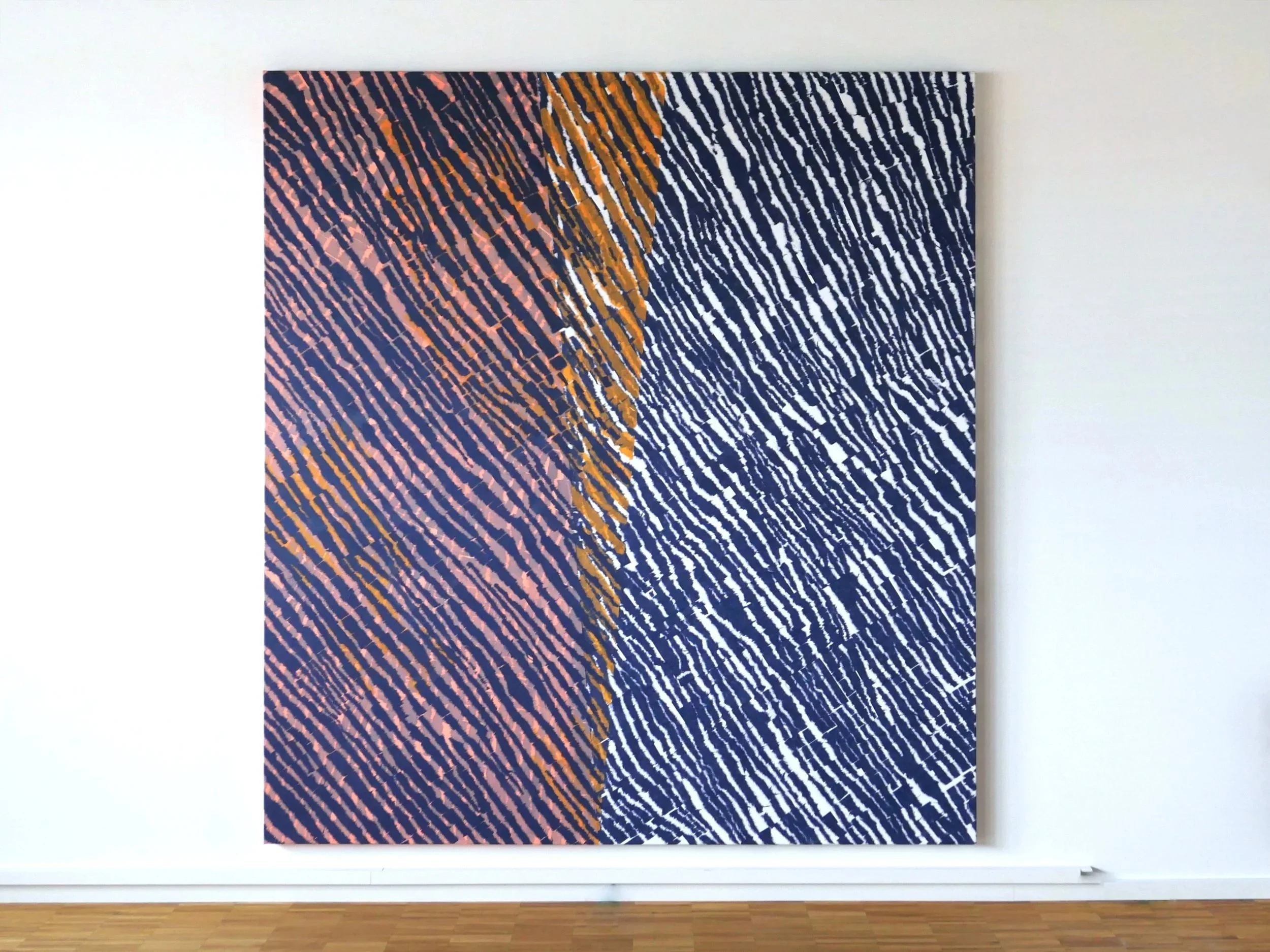 An abstract painting with diagonal streaks in orange, black, and white on a dark background, hanging on a white wall in a gallery.