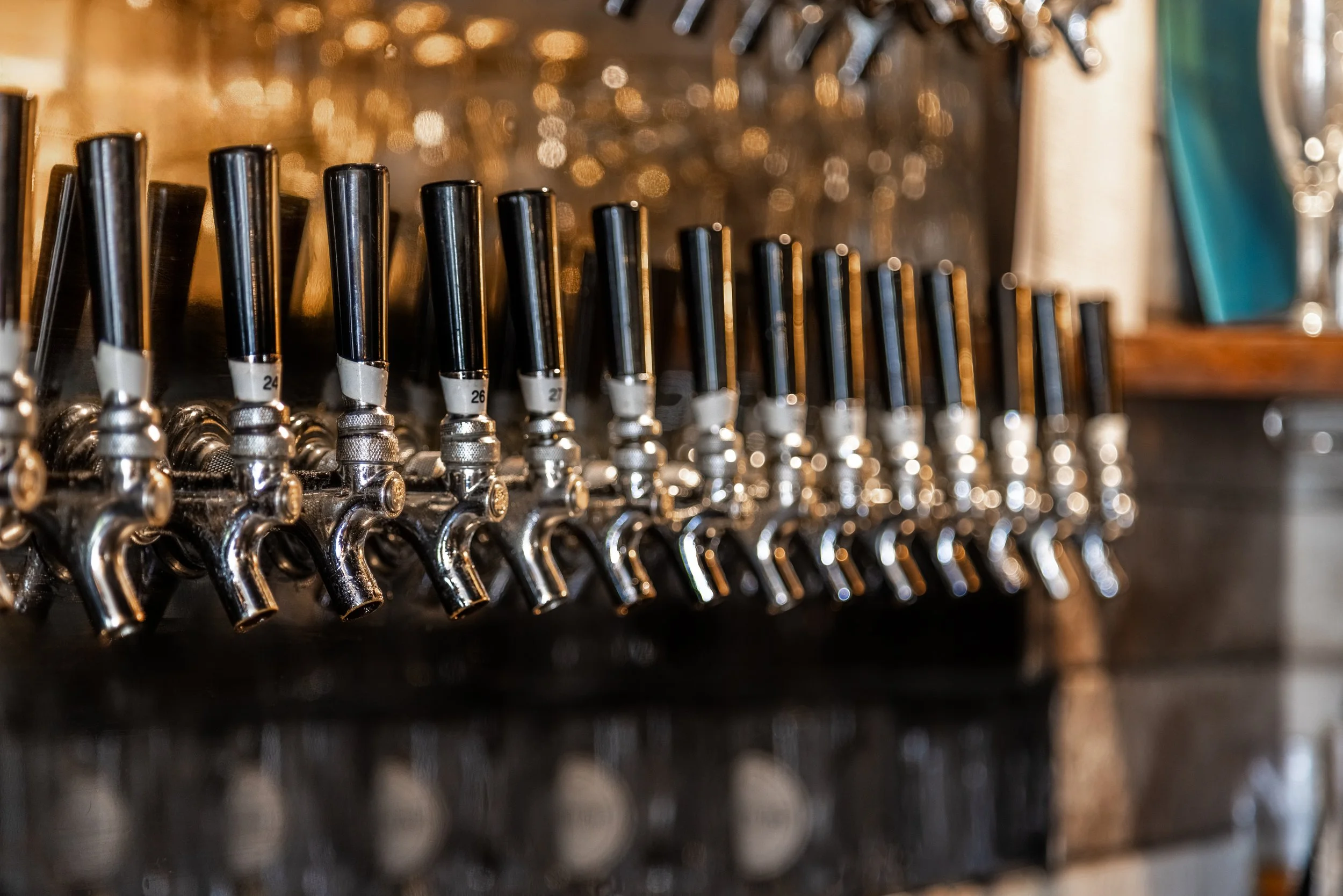 Some of the 36 craft beer tap handles lined up in a row at The Joyce pub.