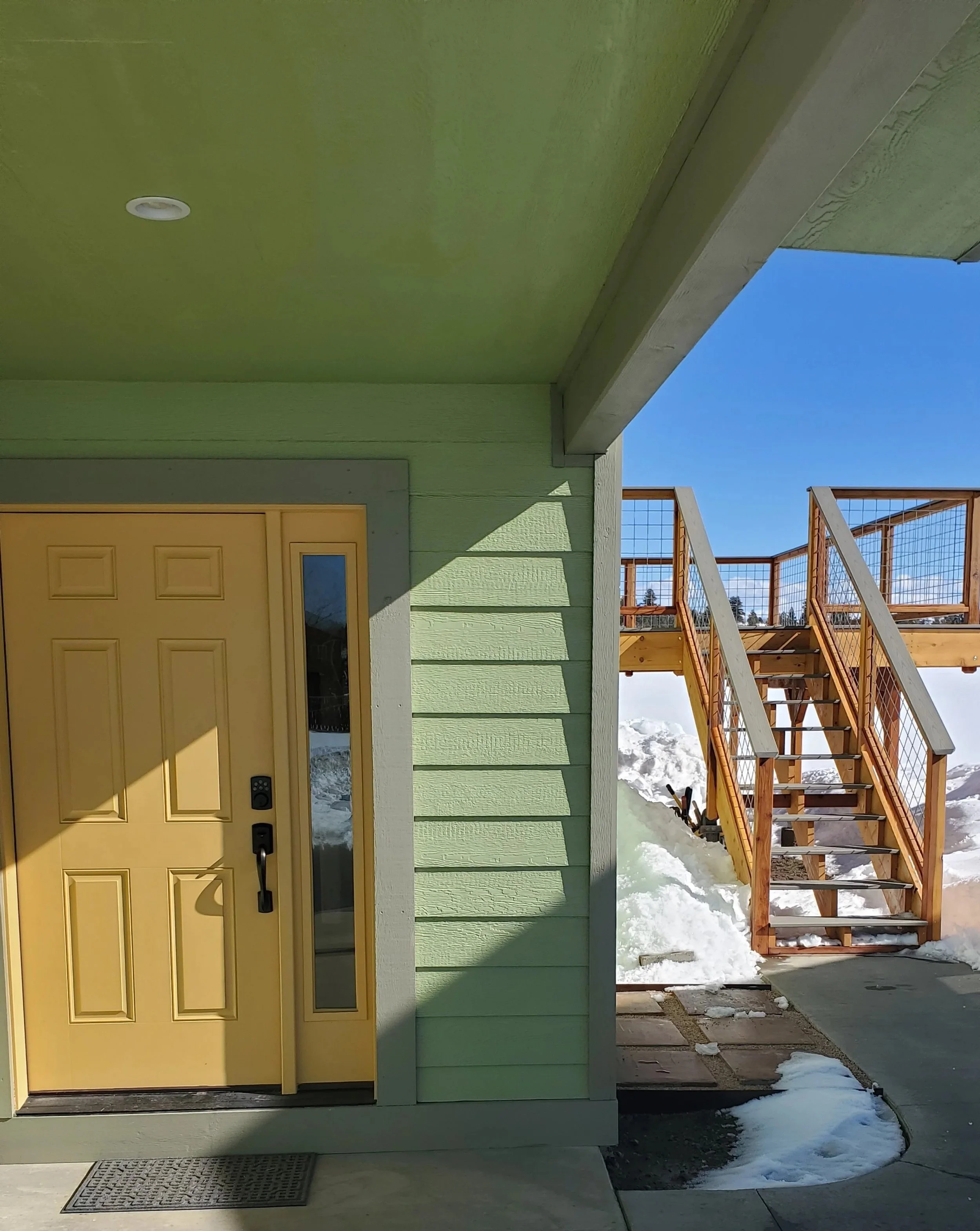 Green house with yellow door