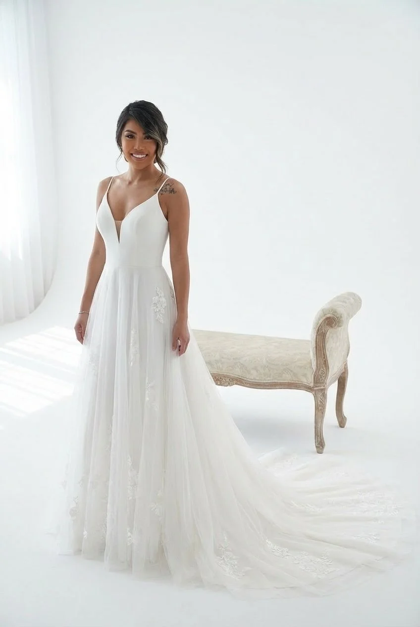 Minimal A-line wedding dress. Clean V-neck bodice with delicate straps. Light flowing skirt with a soft train. Made from chiffon and fine tulle. Effortless modern wedding gown.