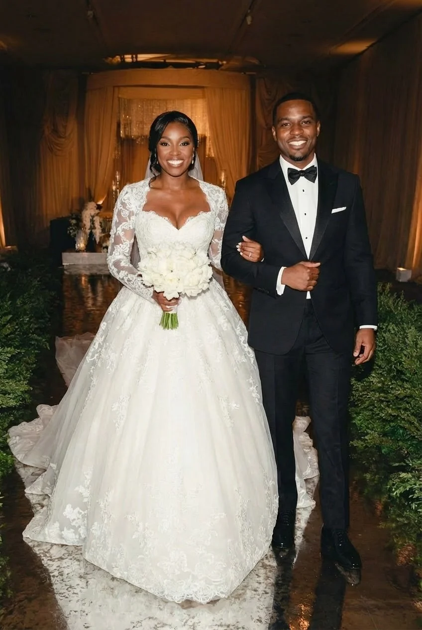 Classic lace ball gown wedding dress. Structured lace bodice with a soft sweetheart neckline and sheer long sleeves. Full ball skirt with layered tulle and lace appliqués. Chapel-length train. Crafted from lace and tulle for a timeless formal bridal 