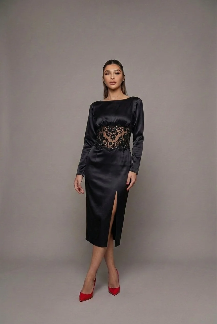 Black silk charmeuse midi dress with a refined, sculpted silhouette.
The design features a bateau neckline and fitted long sleeves, creating a clean, elongated upper line. The bodice and skirt are cut close to the body in a sleek pencil shape, emphas