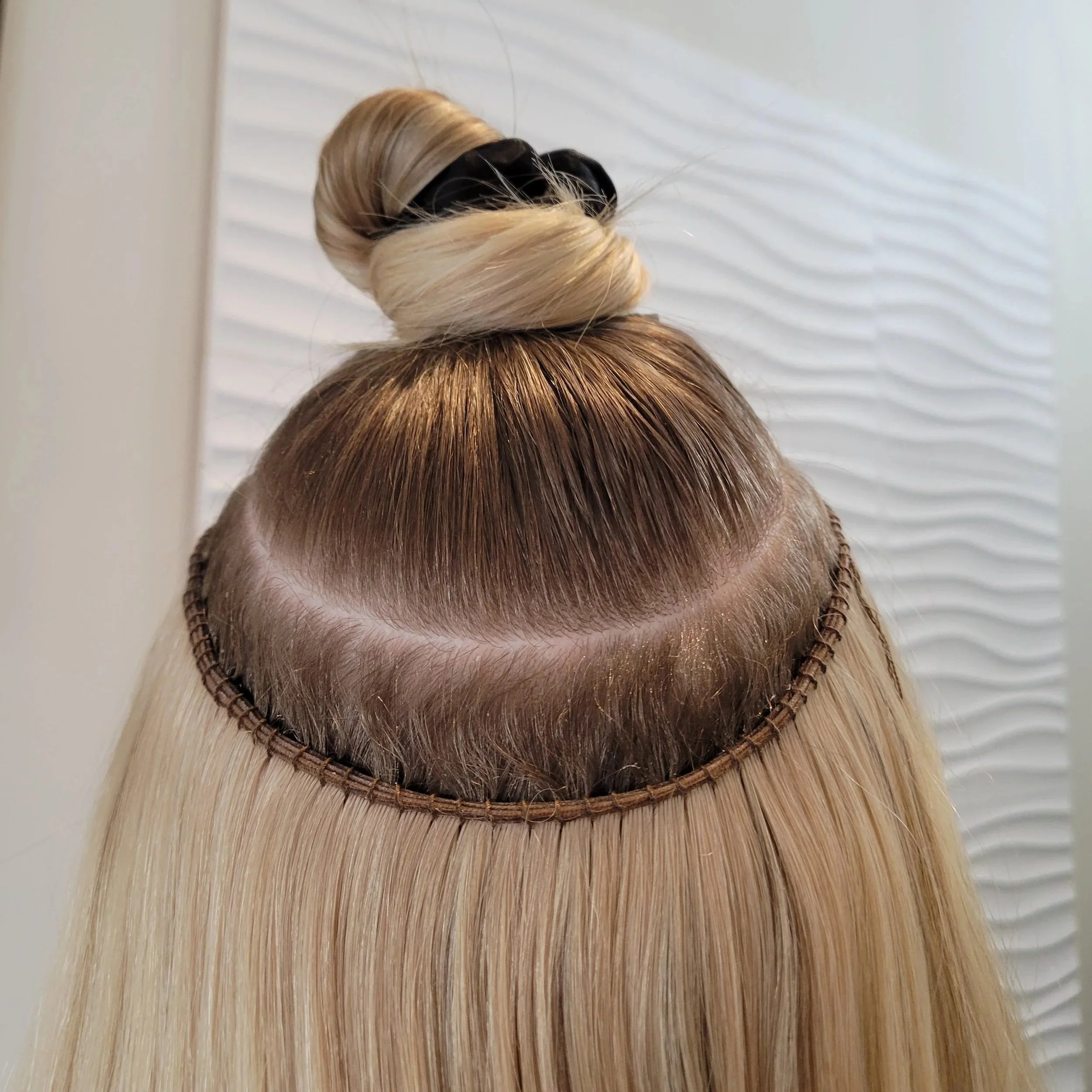 Blonde hair with a lace front wig, showing the hairline and natural hair growth underneath.