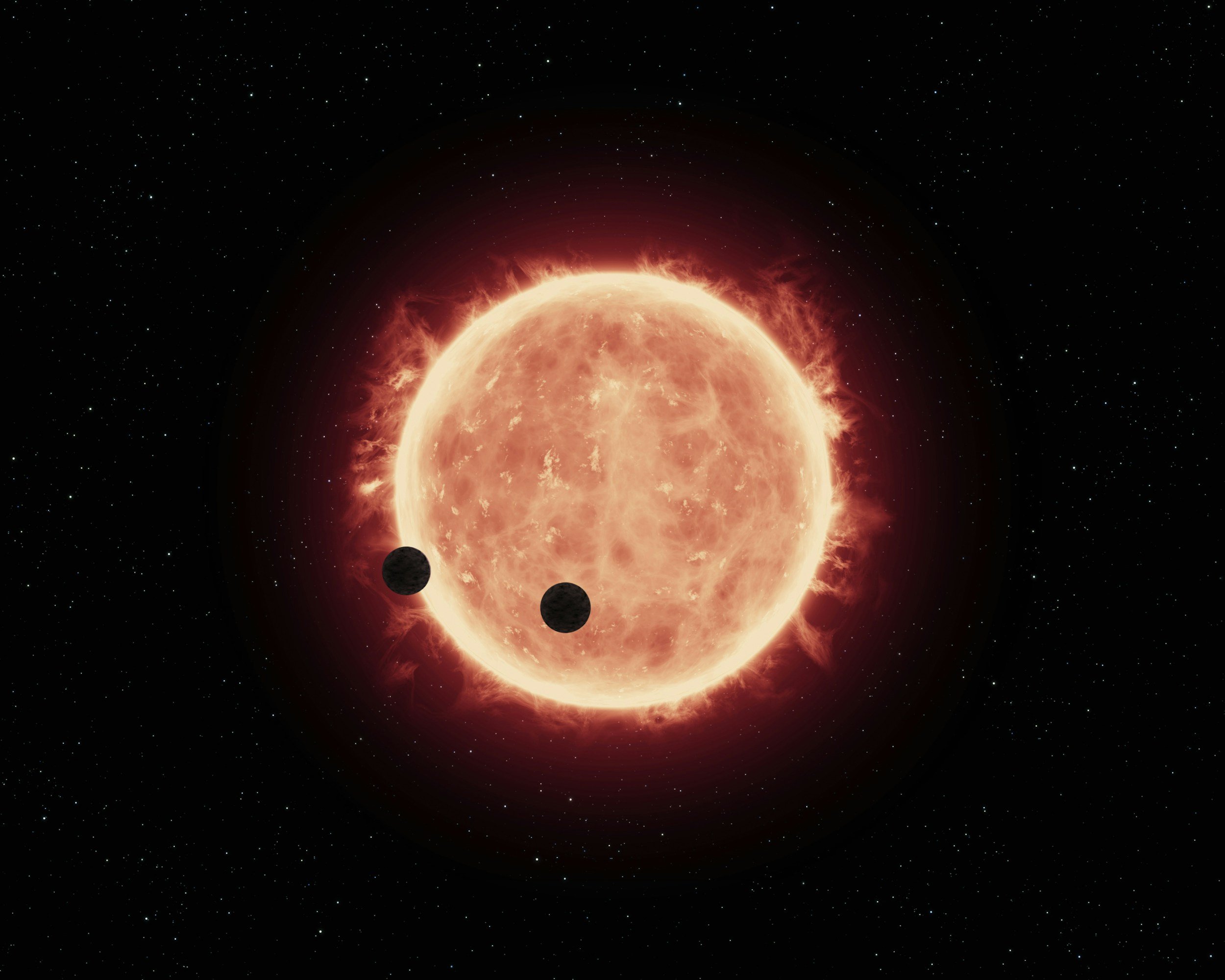 A digital depiction of a starry space scene featuring a large, glowing orange star with two dark planets orbiting nearby.