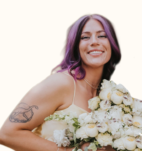 Girl with pink hair holding a bouquet of flowers