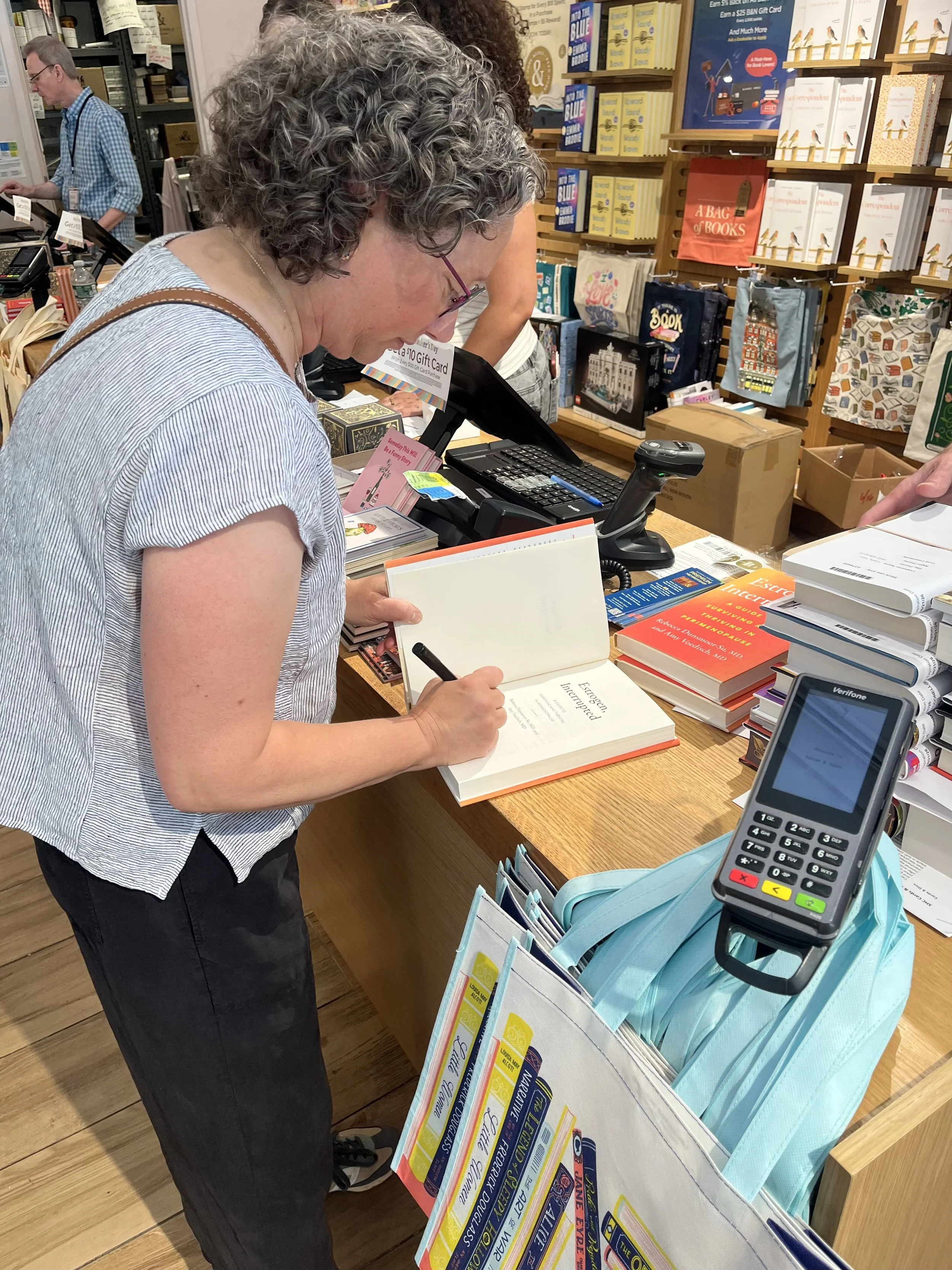 Dr. Rebecca Dunsmoor-Su signs a copy of Estrogen, Interrupted