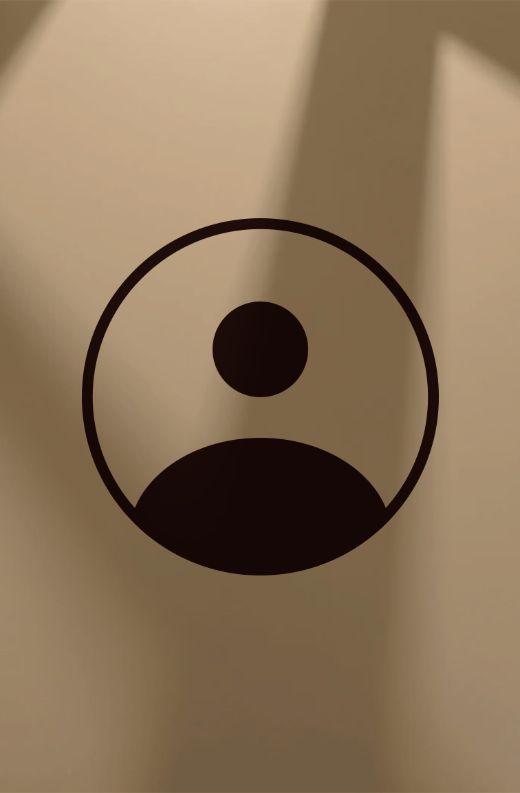 Woman sitting on a bench in a modern interior with wooden wall panels, wearing a sleeveless beige top and loose brown pants, casting a shadow on the wall.