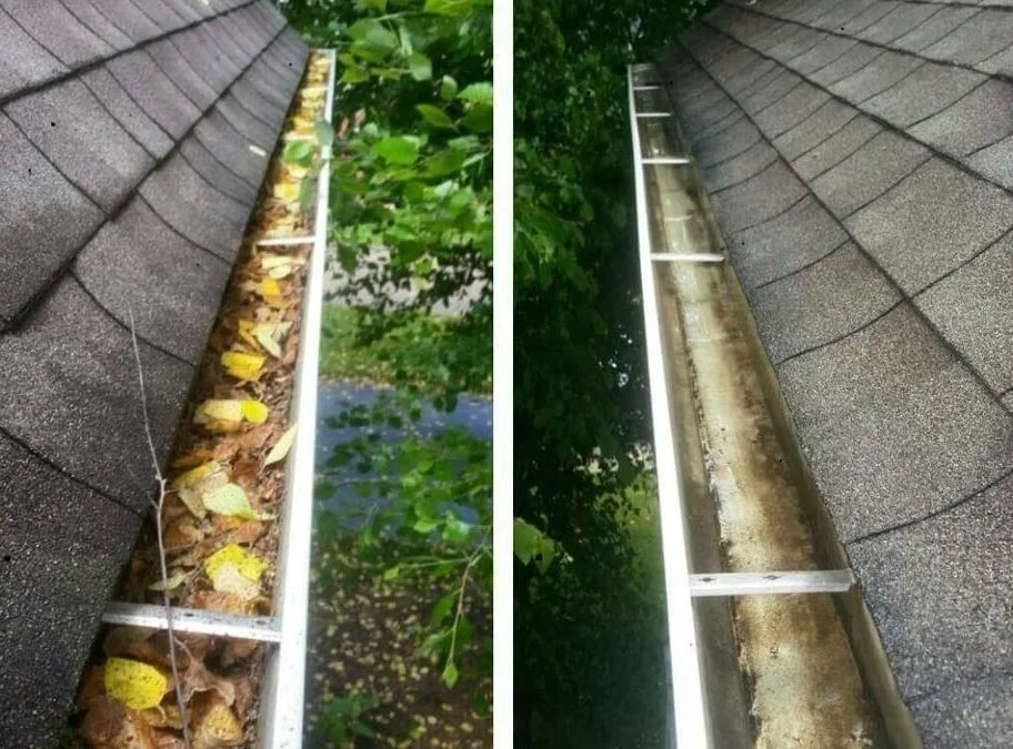 Comparison of two gutter sections: the left side filled with leaves and debris, the right side cleared and clean, attached to a shingled roof with green foliage in the background.