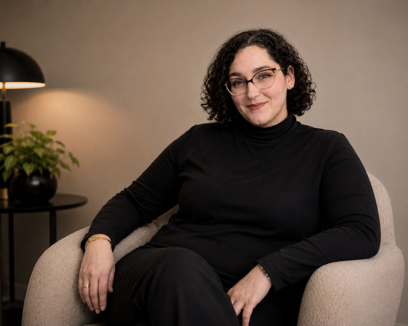 Relationship therapist federal way sits in chair, background neutral, black turtleneck