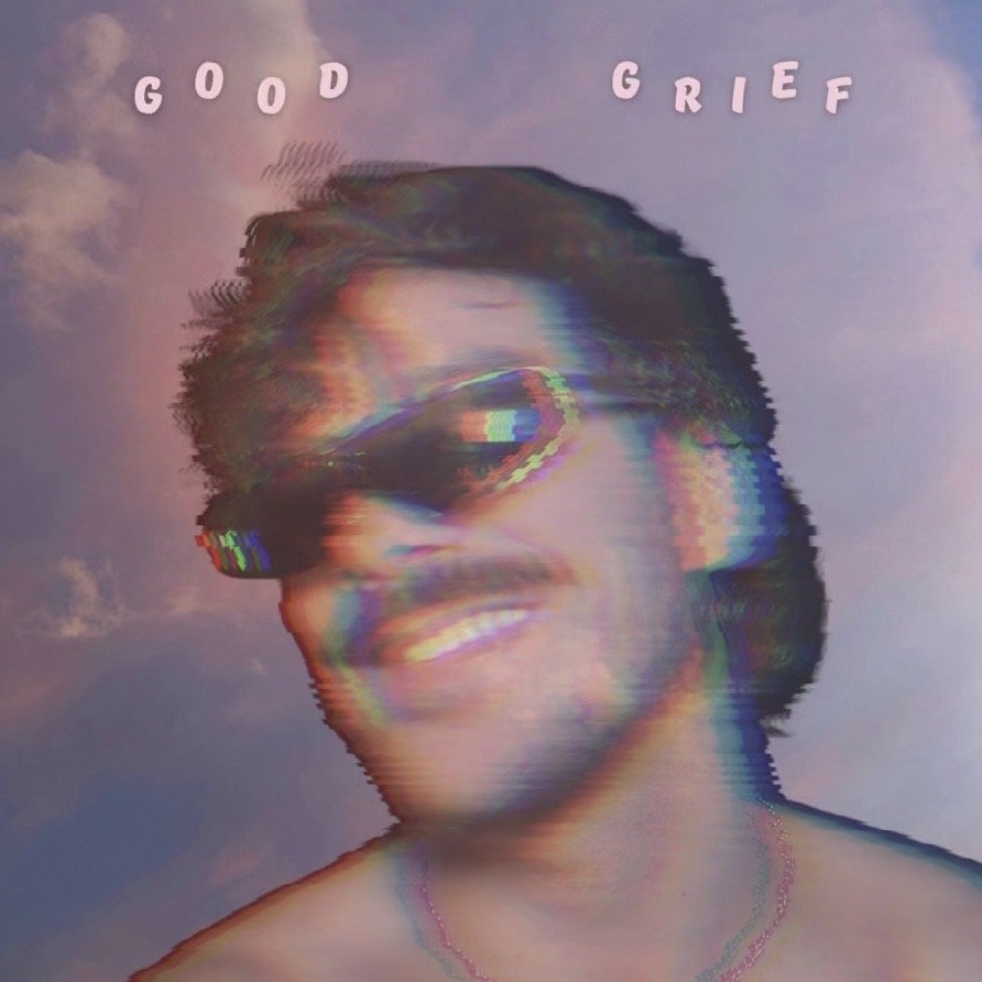 Grayscale portrait of a smiling person wearing sunglasses, with a rainbow glitch effect. Text above reads 'GOOD' on the left and 'GRIEF' on the right, against a cloudy sky background. Max Boyle