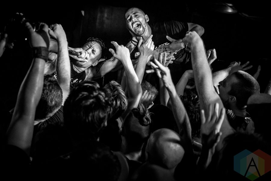 Black and White image of two band members singing in front of a crowd.