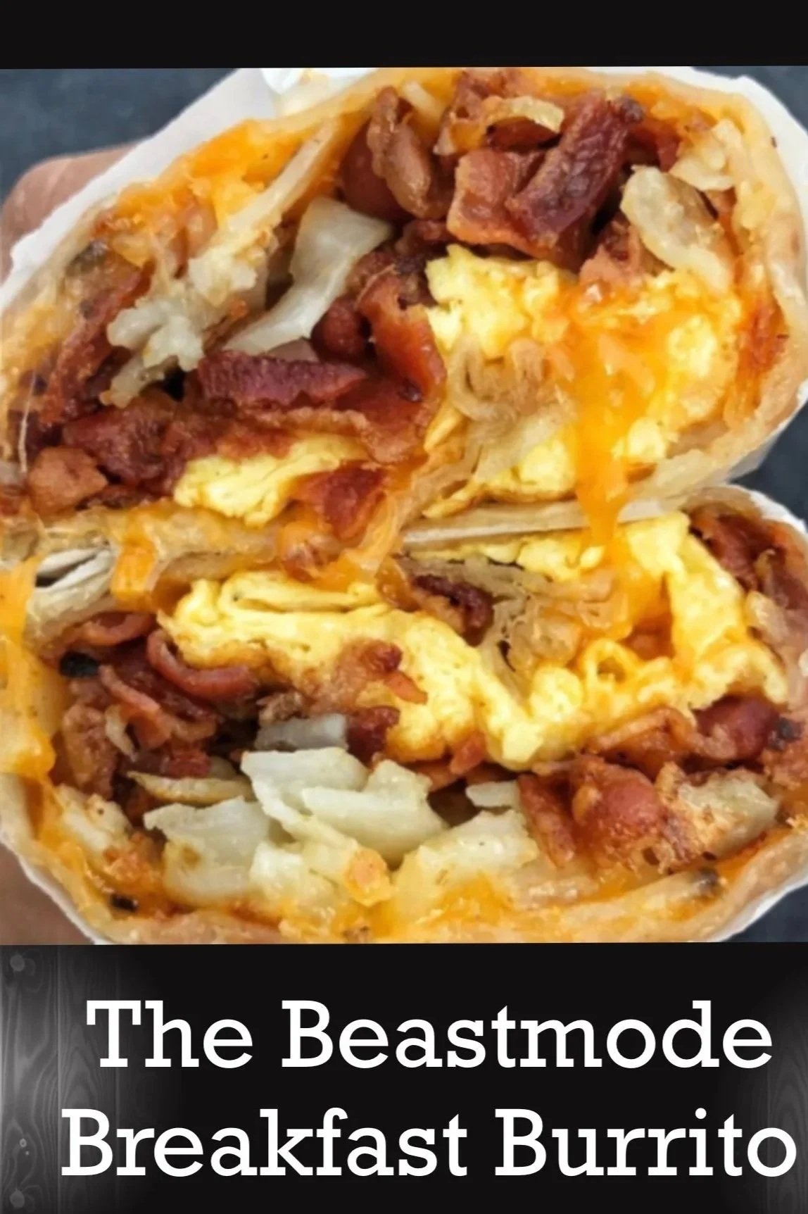 A breakfast burrito filled with scrambled eggs, bacon, sausage, and cheese
