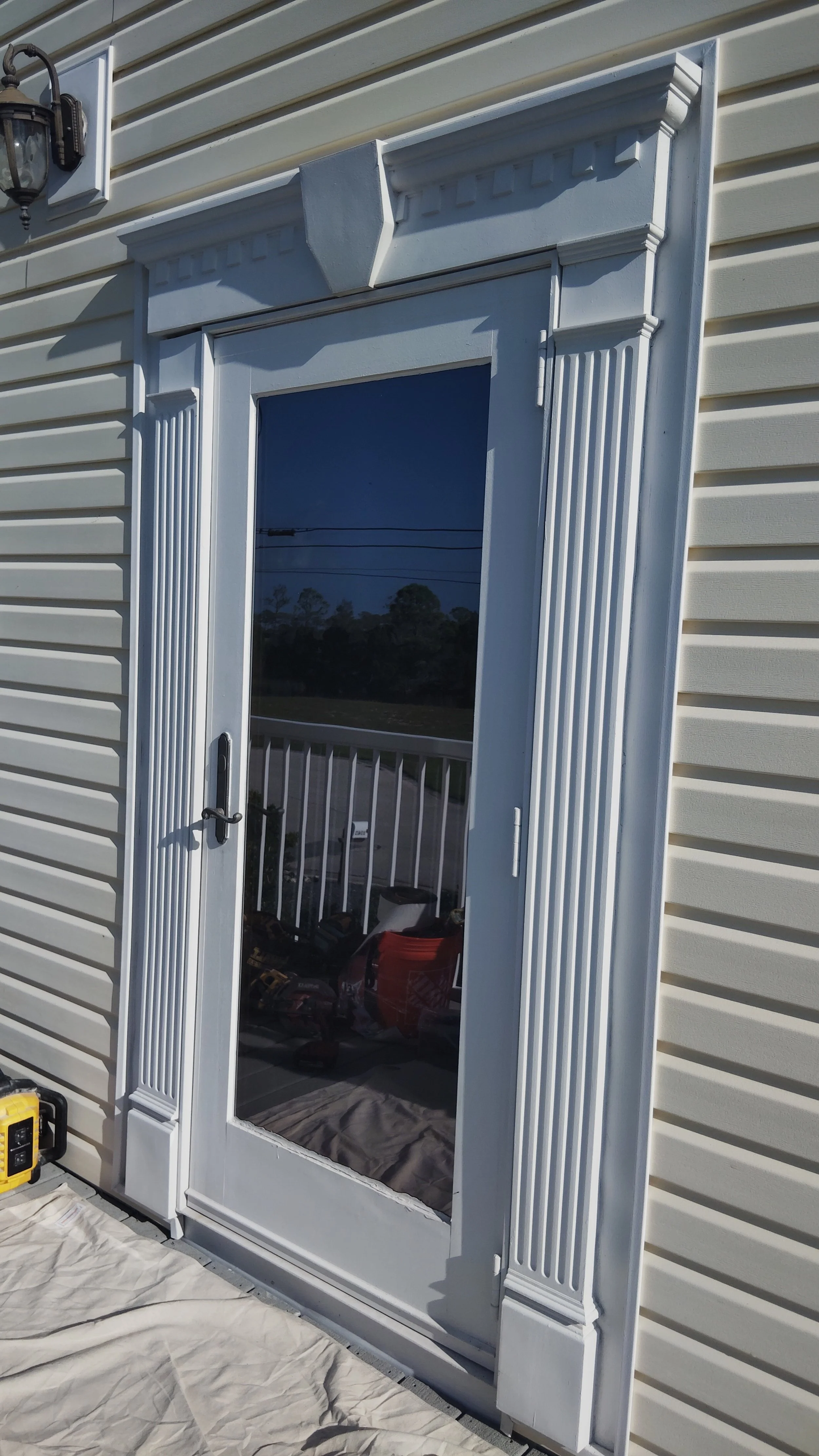Exterior door installation with detailed trim and clean finish on residential siding