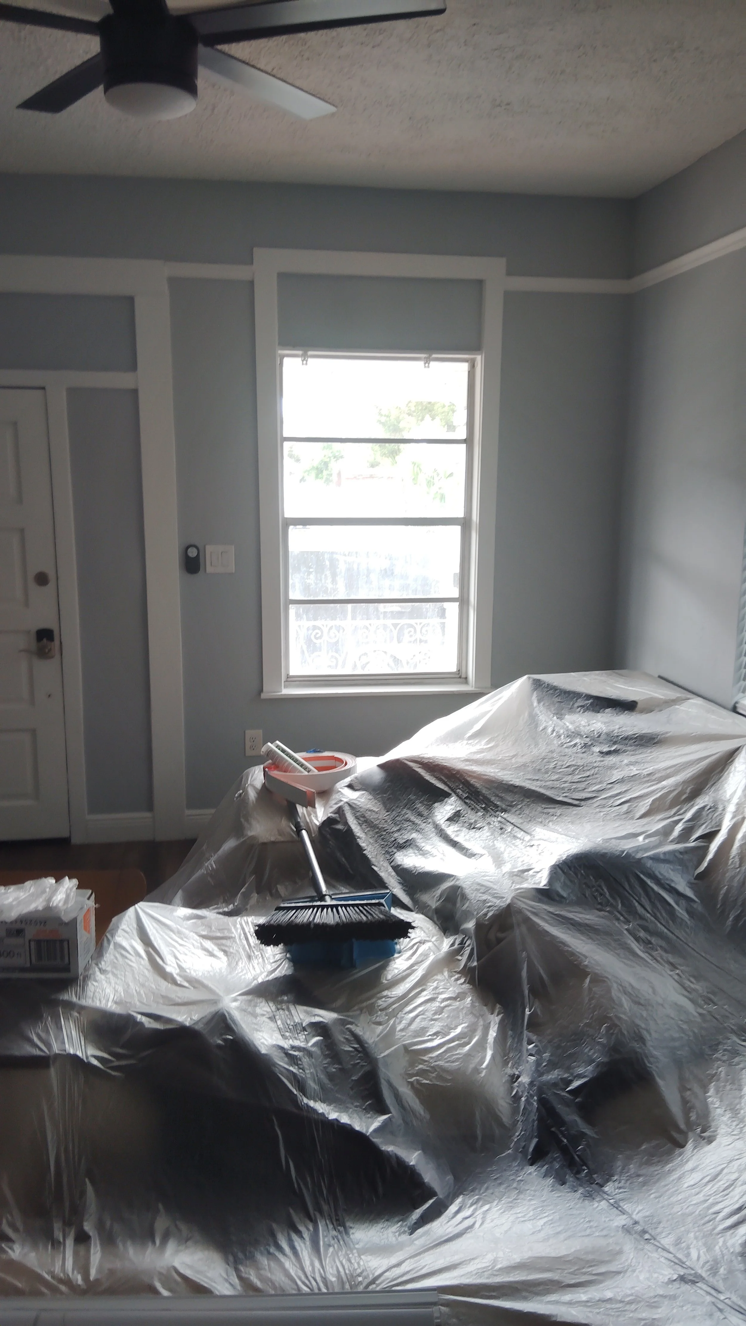 Interior room protected with plastic covering during window installation