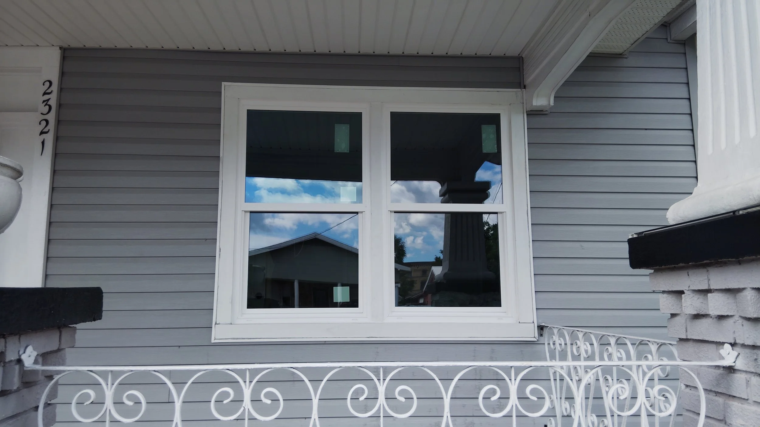 Two exterior windows installed evenly with clean trim on residential home