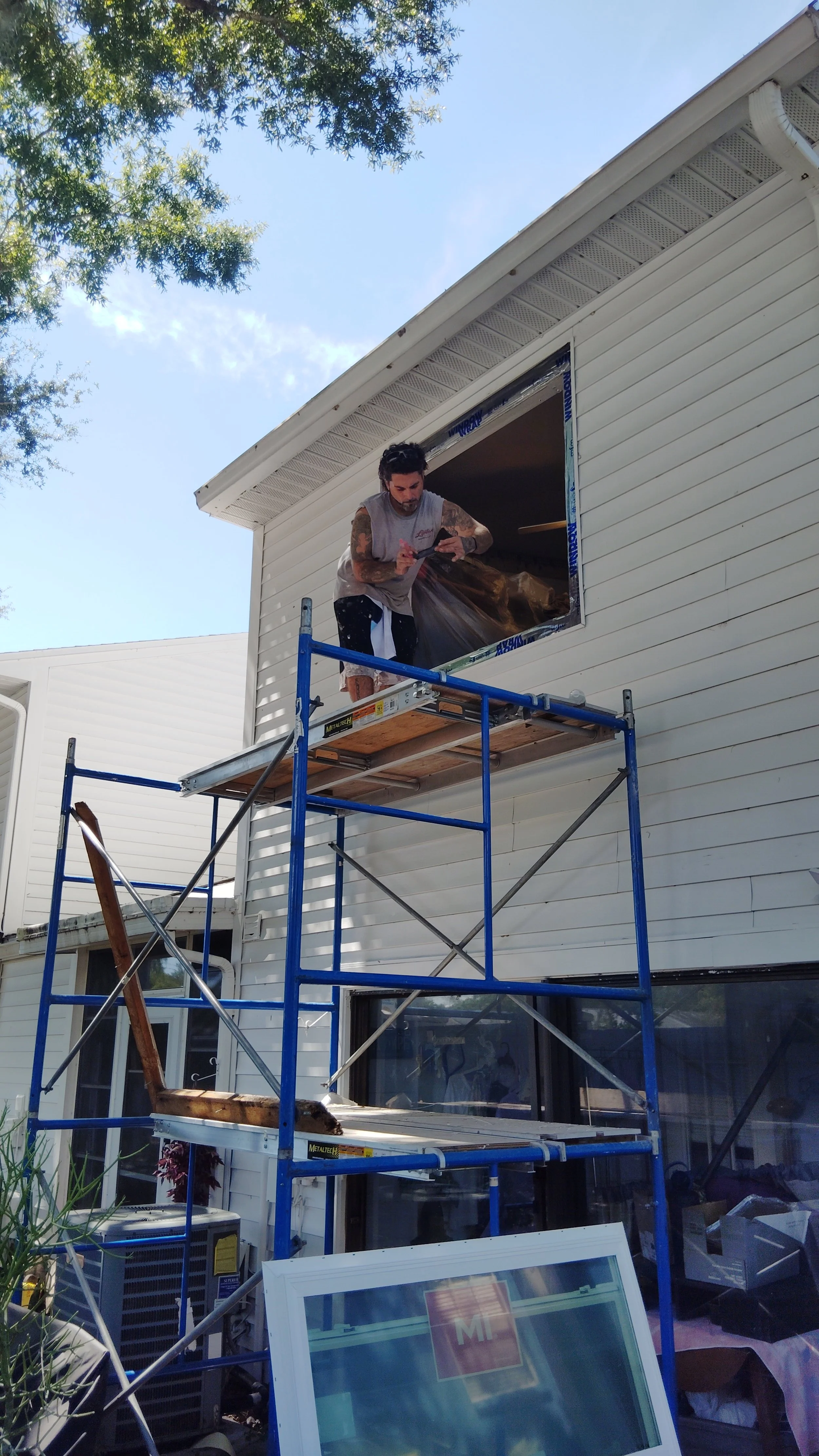 Window installation from scaffolding with controlled access and proper opening prep