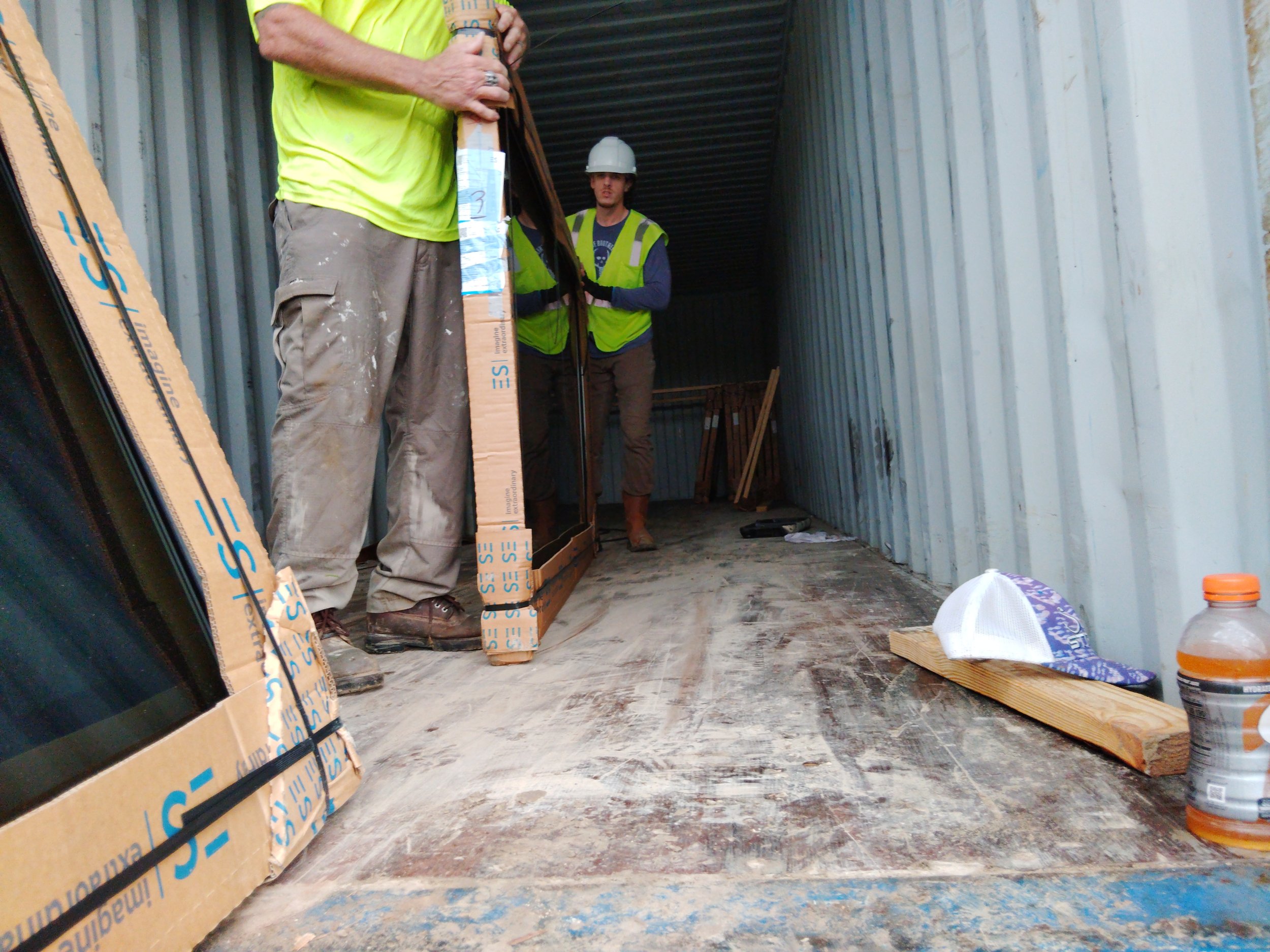 Window units staged and handled carefully on an active jobsite