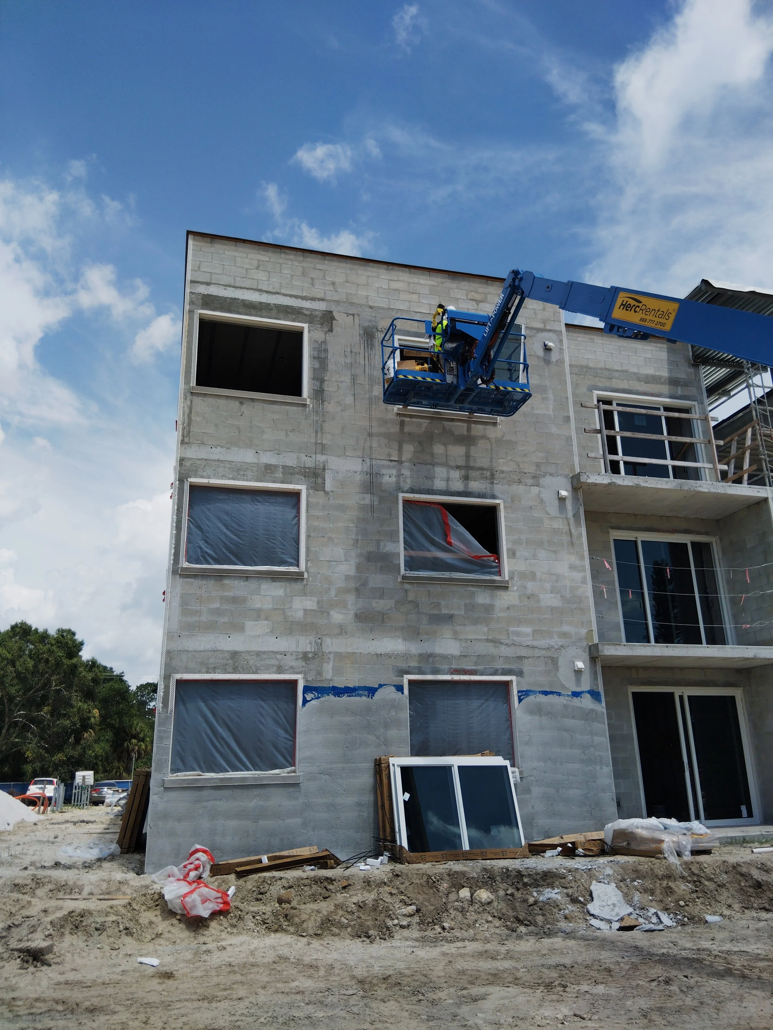 Window installation on a multi-family apartment building using lift equipment