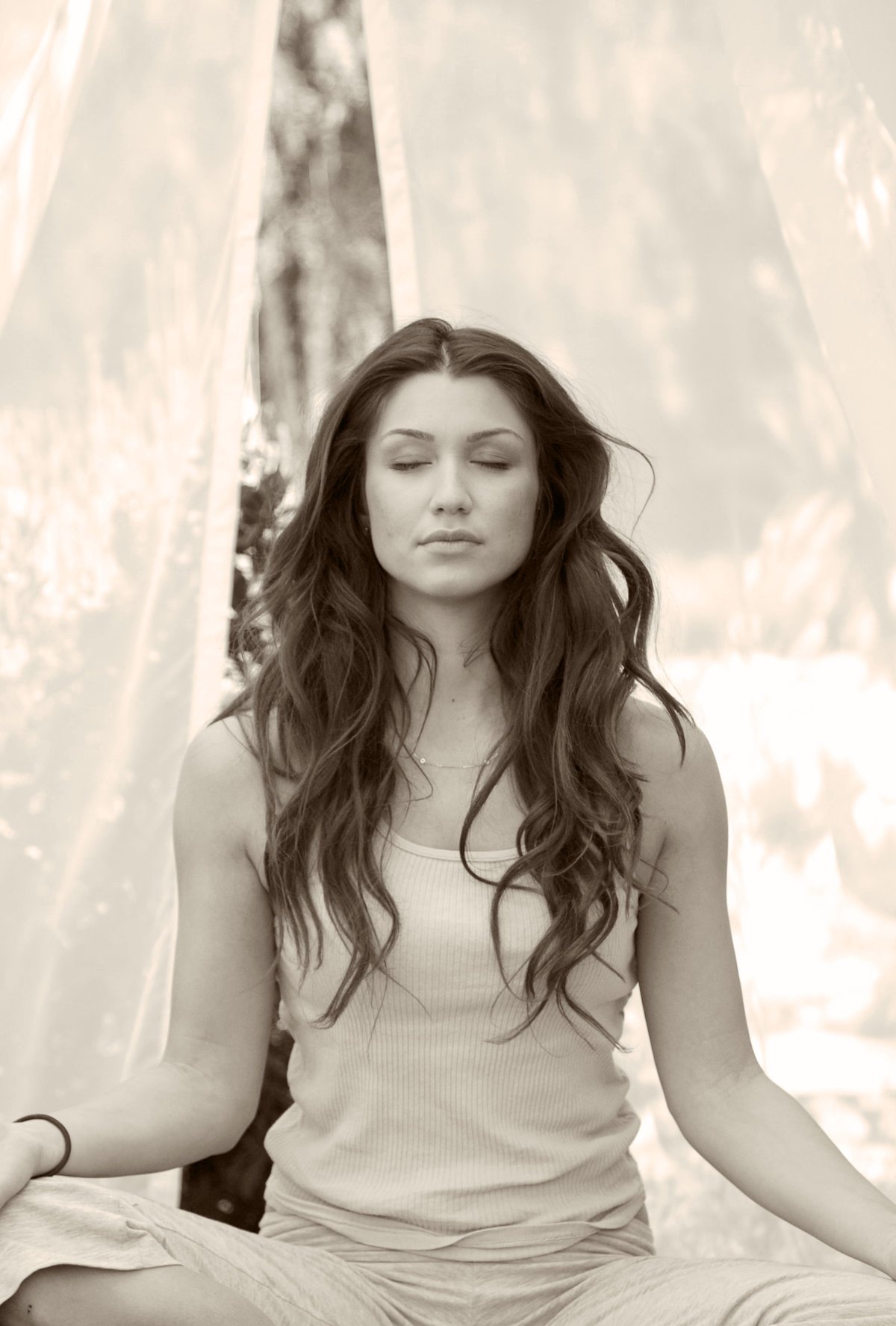 Woman meditating with eyes closed, promoting self-awareness, confidence, and positive self-image