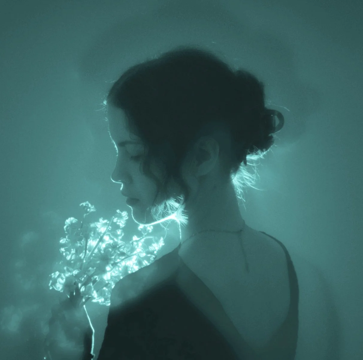 Woman wearing a white hoodie with the words 'Go Love Yourself', promoting Kerry Christie’s self-love merchandise