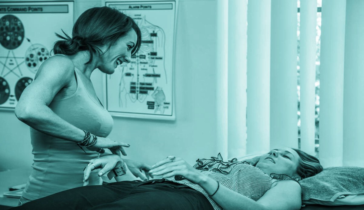 Kerry Christie performing a kinesiology session to support healing and emotional balance