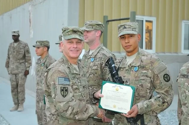 Jonathan Harris receiving an Army Acheivement Medal for his work during his deployment to Afghanistan in 2013