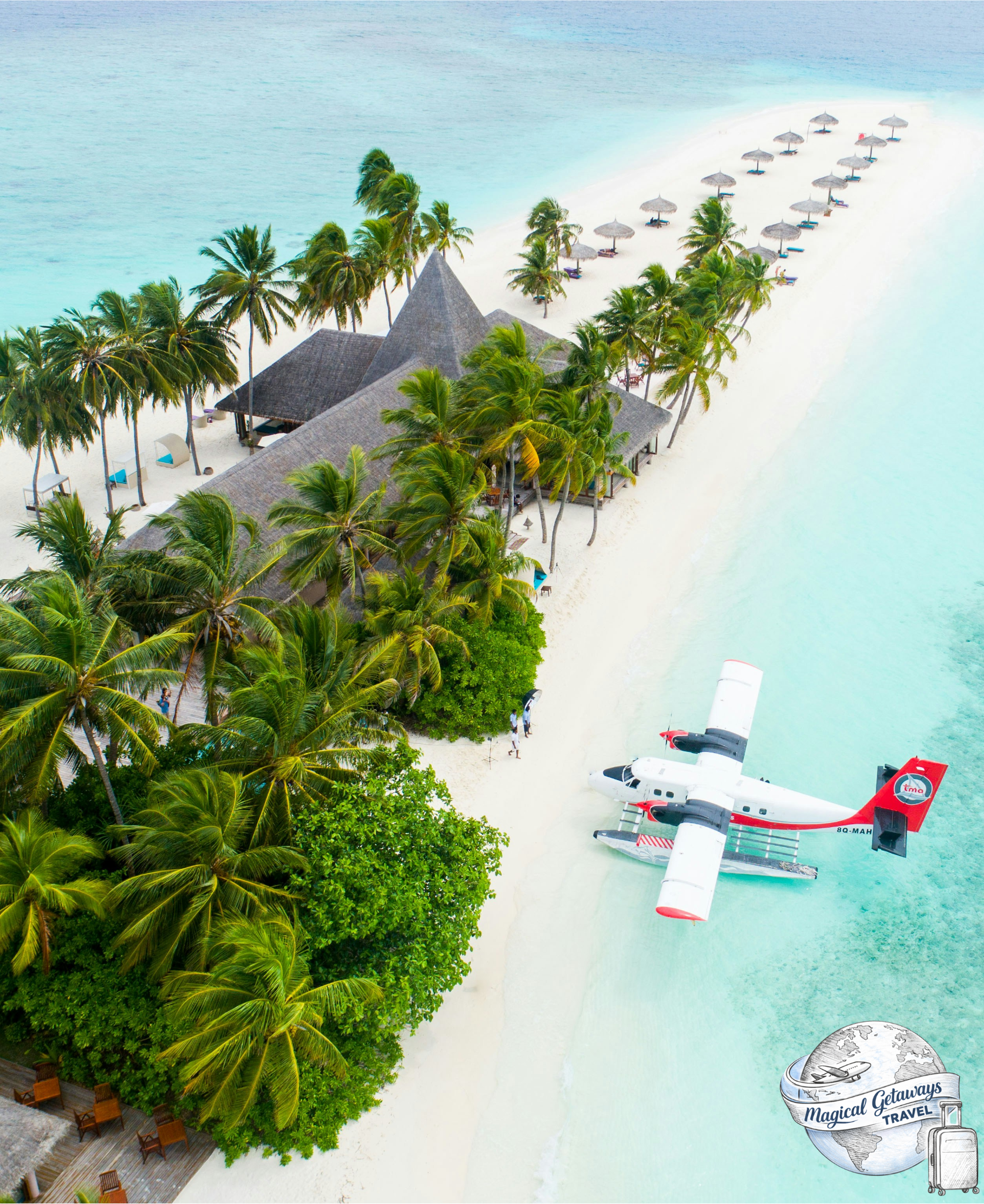 Aerial view of a tropical beach resort with a thatched-roof building, numerous palm trees, lounge chairs under umbrellas, and a seaplane on the white sandy beach near turquoise water. Travel agent, travel advisor.