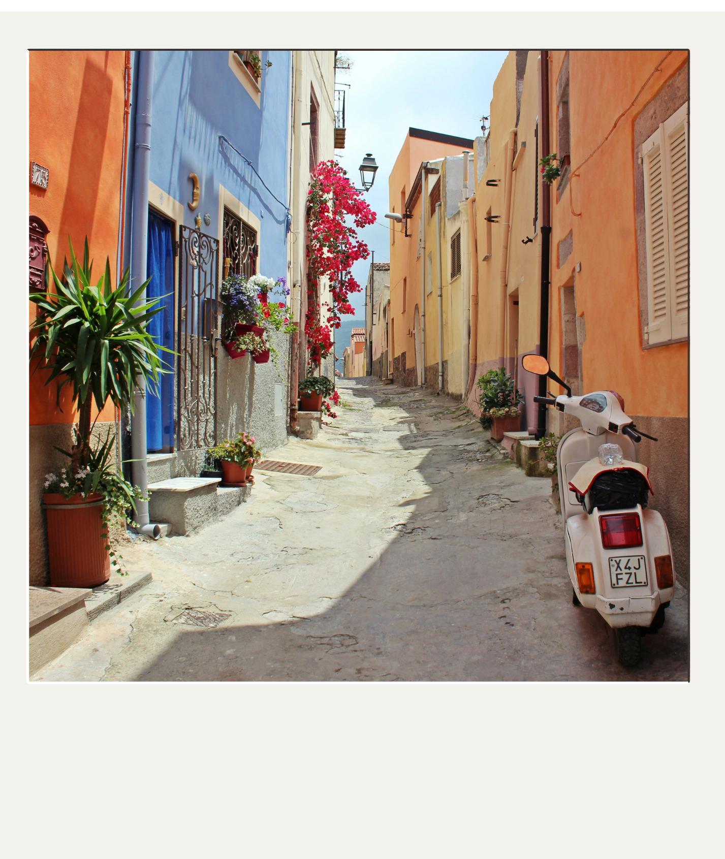 Colorful narrow European street with pastel buildings, potted plants, and a vintage scooter.