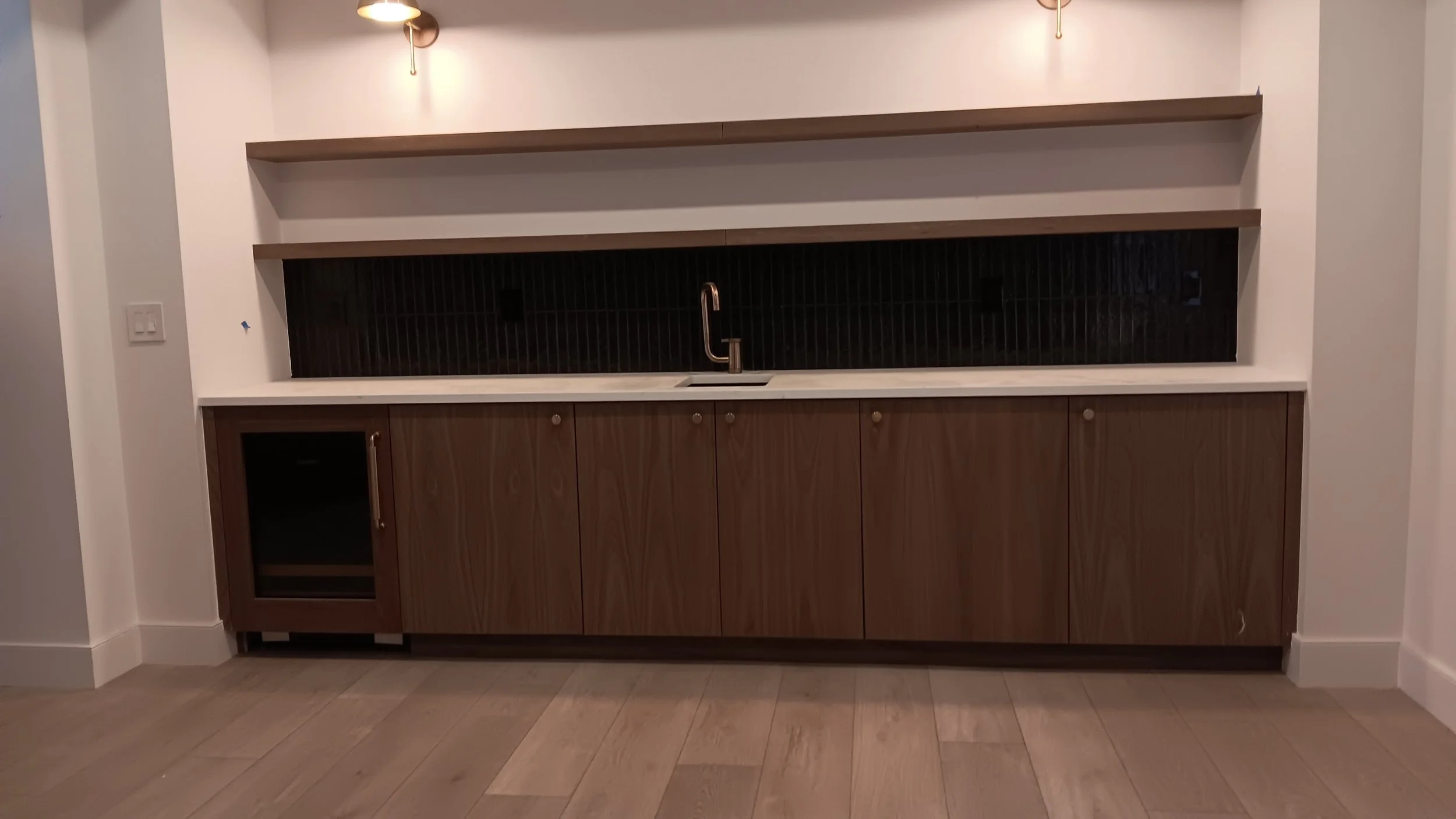 Custom powder room cabinetry with precision-mitered raised panels.