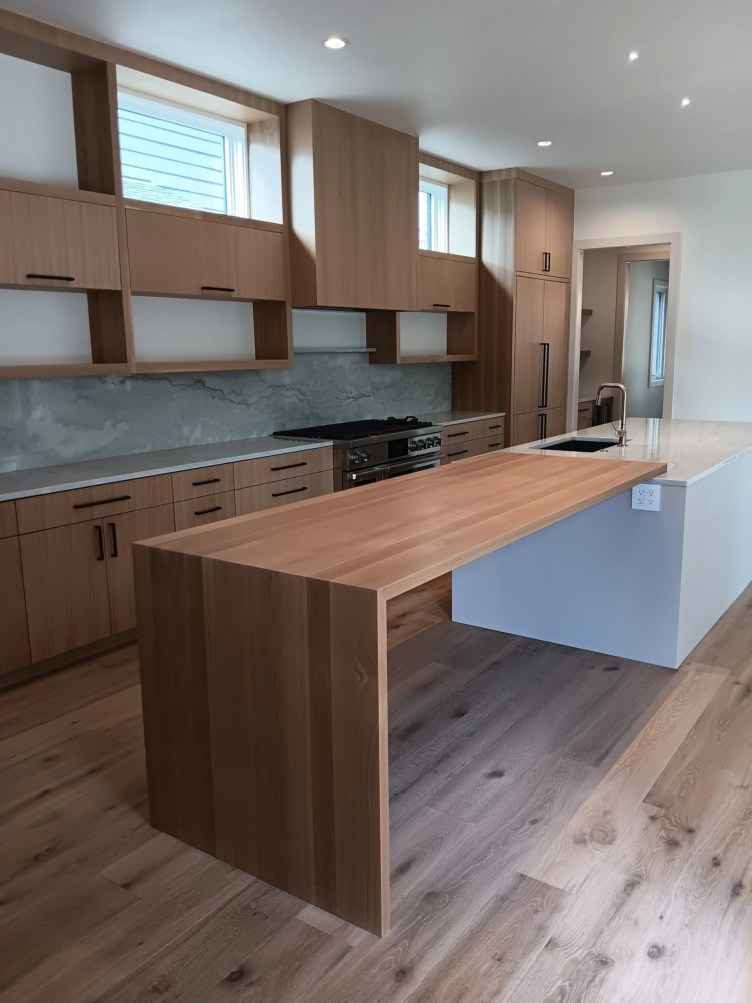 Bespoke bathroom millwork featuring antique brass hardware.